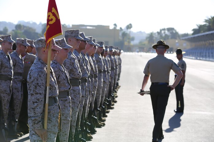 Recruits of Company K, 3rd Recruit Training Battalion, fall into formation during Final Drill aboard the depot, Sept. 23.  Recruits are graded by Drill Masters on a wide range of items including proper uniform, excessive movement and proper execution of a drill maneuver.