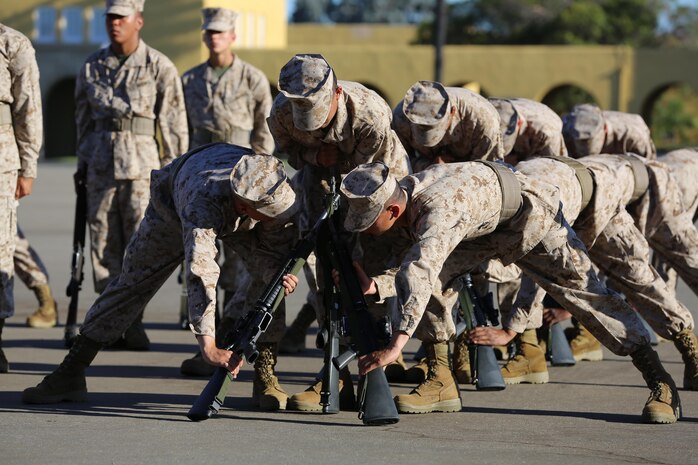 Recruits of Company K, 3rd Recruit Training Battalion, perform stack arms during Final Drill aboard the depot, Sept. 23.  Recruits must quietly communicate and coordinate with one another to ensure weapons are placed correctly so they will not fall.