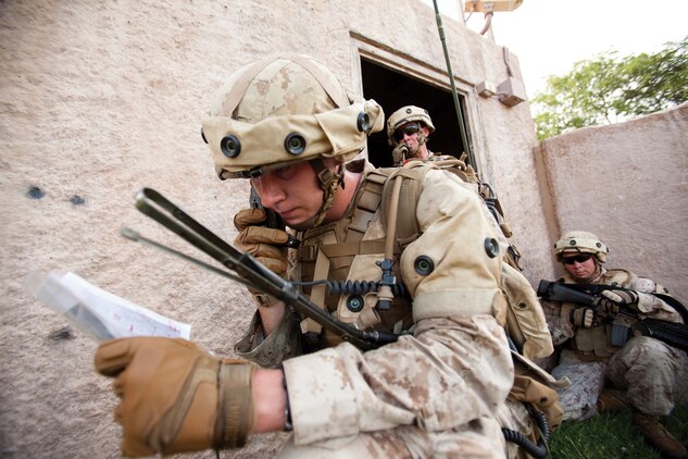 Lance Cpl. Brennan Tuman, a radio operator with first platoon, Charlie Company, 1st Battalion, 3rd Marine Regiment and Coal Center, Pa., native, relays radio traffic from a fire support team during Military Operations in Urban Terrain training at Marine Corps Training Area Bellows, Hawaii, Sept. 30, 2013. During the exercise, the Marines inegrated a fire support team to call in simulated artillery, 81 mm and 60 mm mortar strikes on enemy positions. (U.S. Marine Corps photo by Cpl. Matthew Callahan)