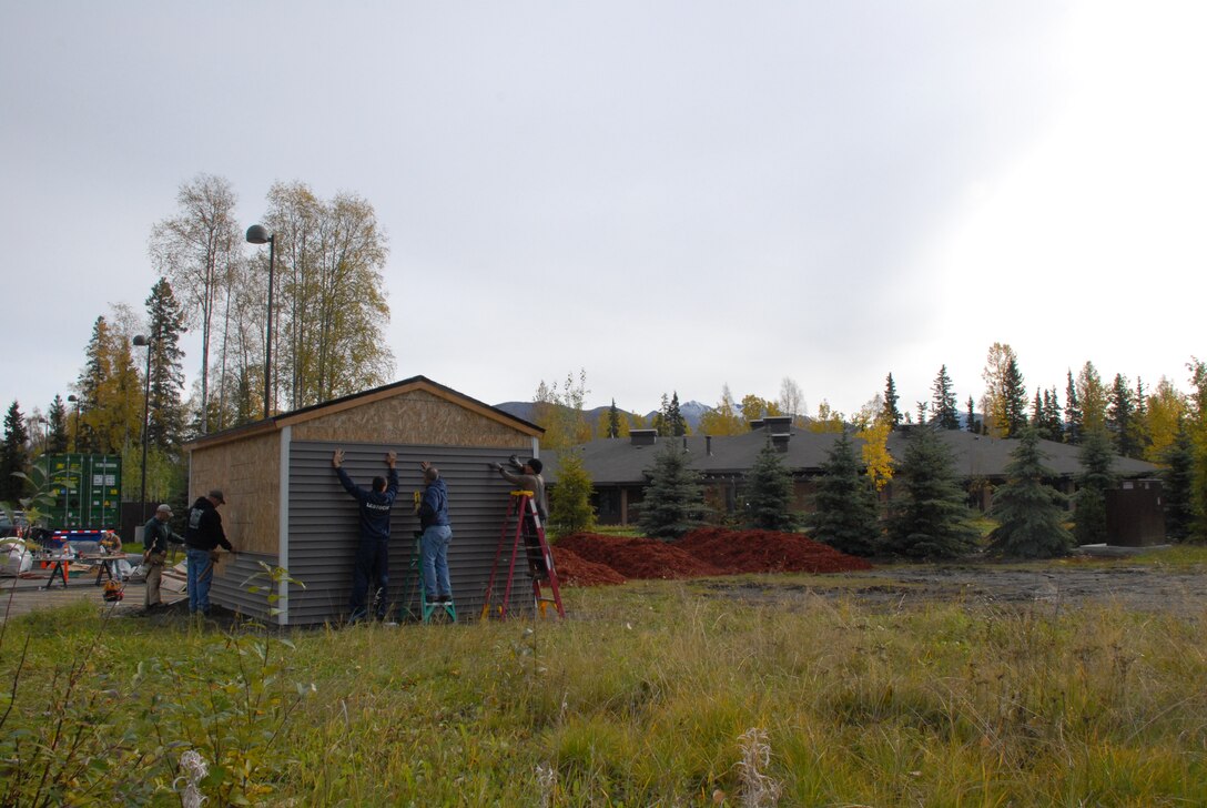 Volunteers from the Alaska District and 2nd Engineer Brigade install siding on a shed they constructed for the Alaska Fisher House on Joint Base Elmendorf-Richardson Sept. 28. The team spent three consecutive Saturdays in September building the shed to give the Fisher House needed storage space. 