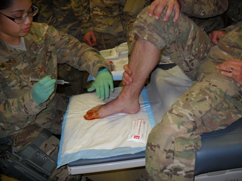 U.S. Air Force Staff Sgt. Erika Osorio, 7th Medical Group, prepares to inject a numbing agent into a patient’s toe at Bagram Airfield, Afghanistan. While deployed in Bagram, Osorio was assigned to the 1st and 10th Sustainment Brigades as a Combat Medic. She worked with an Army unit that conducted convoy operations throughout the region. In March of 2013 she was awarded the Air Force Combat Action Medal. (Courtesy Photo)