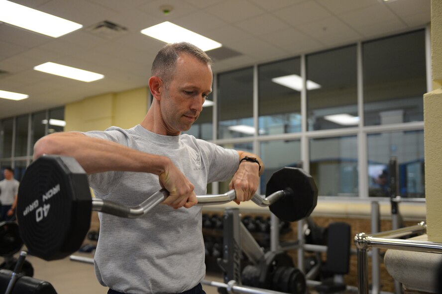 Col. Leland Bohannon, 2nd Bomb Wing vice commander, lifts weights at the Senior Airman Bryan R. Bell Fitness Center on Barksdale Air Force Base, La., Oct. 11. 2013. Bohannon visited the facility to open the newly renovated weight room. The first phase for the weight room took approximately three months to complete. The fitness center is scheduled to undergo two more renovation phases. (U.S. Air Force photo/Senior Airman Micaiah Anthony)