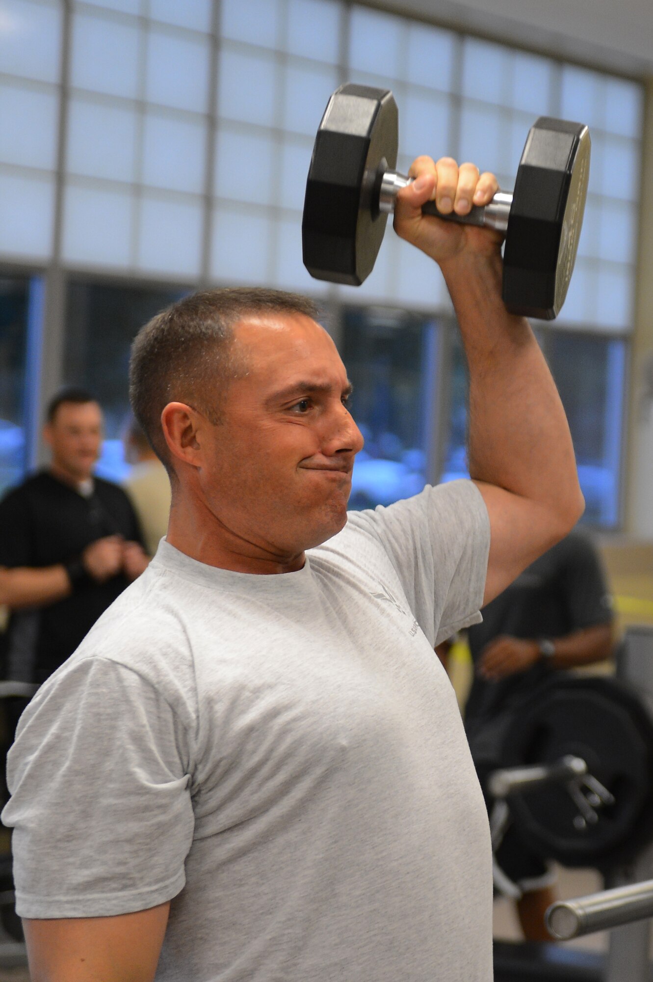 Chief Master Sgt. Curtis Storms, 2nd Bomb Wing command chief, lifts weights at the Senior Airman Bryan R. Bell Fitness Center on Barksdale Air Force Base, La., Oct. 11, 2013. Storms visited the facility to participate in the grand opening of the newly renovated weight room. The fitness center is scheduled for more renovations to include the locker and aerobics room. (U.S. Air Force photo/Senior Airman Micaiah Anthony)
