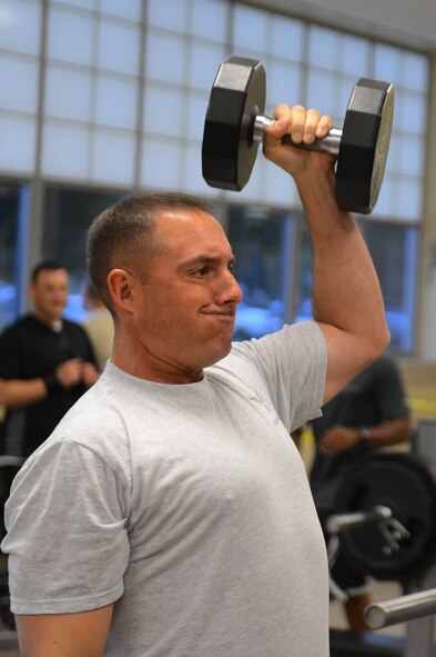 Chief Master Sgt. Curtis Storms, 2nd Bomb Wing command chief, lifts weights at the Senior Airman Bryan R. Bell Fitness Center on Barksdale Air Force Base, La., Oct. 11, 2013. Storms visited the facility to participate in the grand opening of the newly renovated weight room. The fitness center is scheduled for more renovations to include the locker and aerobics room. (U.S. Air Force photo/Senior Airman Micaiah Anthony)
