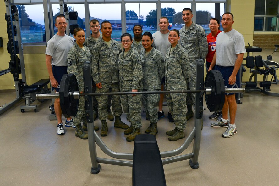 Col. Leland Bohannon, left, 2nd Bomb Wing vice commander, Lt. Col. Diane Benavidez, 2nd Force Support Squadron commander, and Chief Master Sgt. Curtis Storms, 2nd BW command chief, pose for a photo with Barksdale's Fab Five and Fitness Center Airmen at the Senior Airman Bryan R. Bell Fitness Center on Barksdale Air Force Base, La., Oct. 11, 2013. Barksdale's leadership visited the Fitness Center to participate in the grand opening of the new weight room. (U.S. Air Force photo/Senior Airman Micaiah Anthony)
