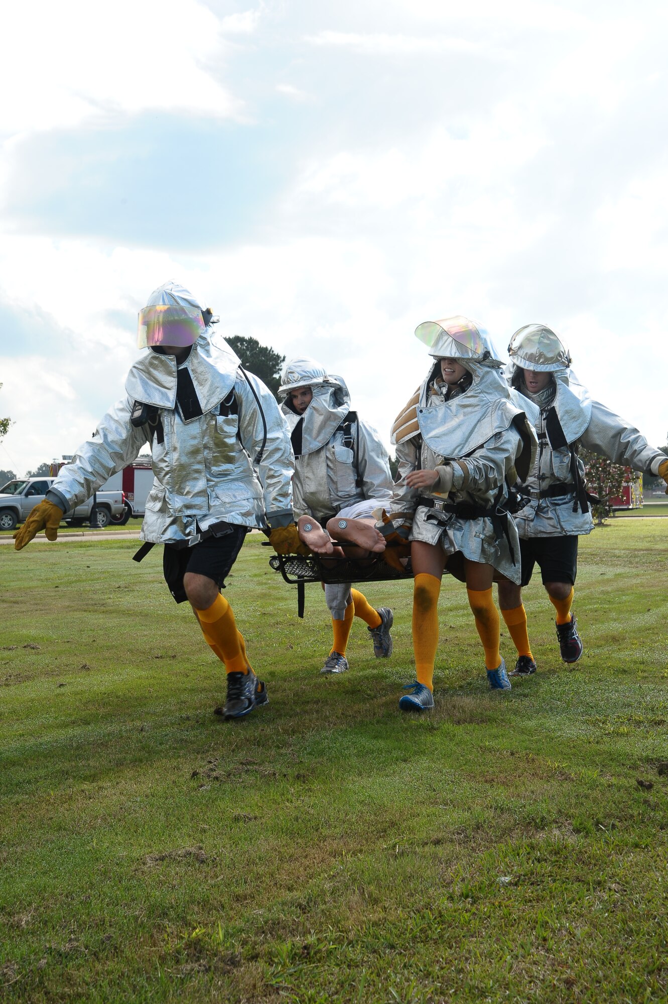 A team of Airmen lift a 210 pound dummy in a competition at the Base Fire Muster Oct. 10 at the Old Fuels Yard on Simler Blvd. (U.S. Air Force Photo/Airman Daniel Lile)