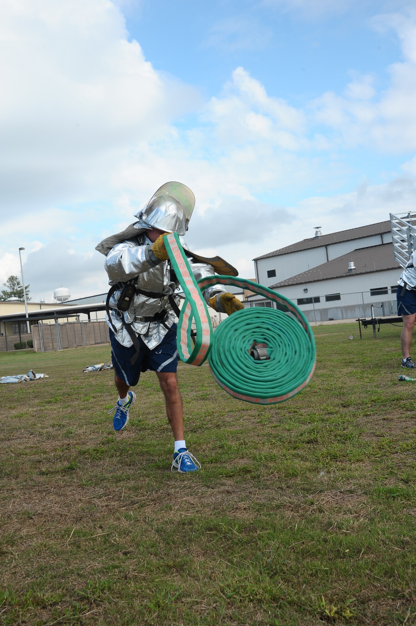 An Airman from Columbus Air Force Base throws a fire hose in the Base Fire Muster Competition Oct. 10 at the Old Fuels Yard on Simler Blvd. (U.S. Air Force Photo/Airman Daniel Lile)