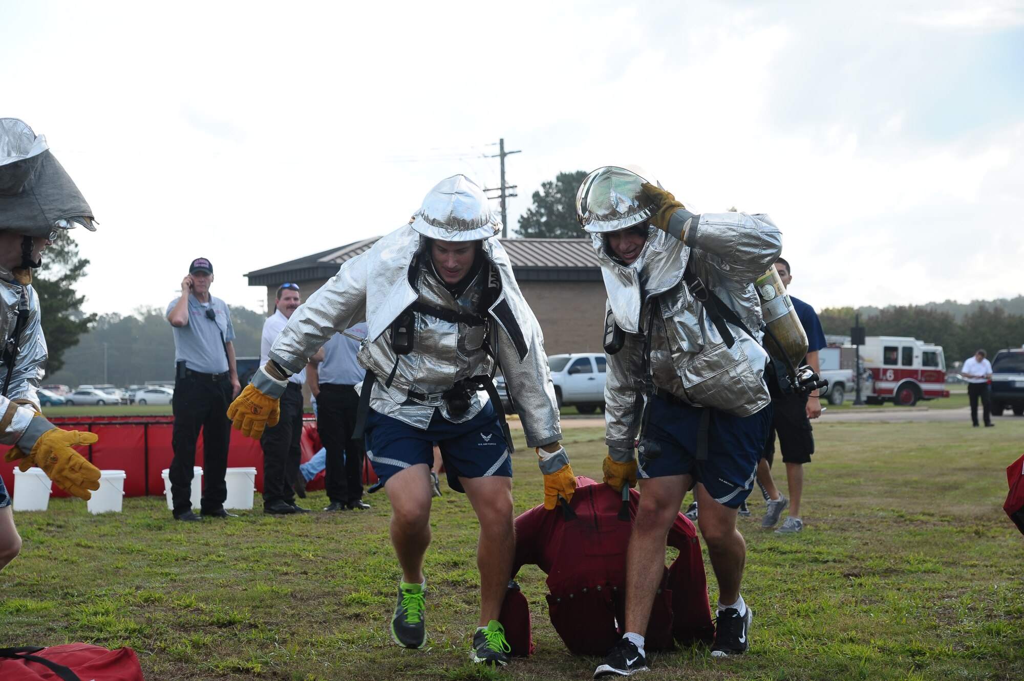 A team of Airmen lift 210 pound dummies in a competition at the Base Fire Muster Oct. 10 at the Old Fuels Yard on Simler Blvd. (U.S. Air Force Photo/Airman Daniel Lile)