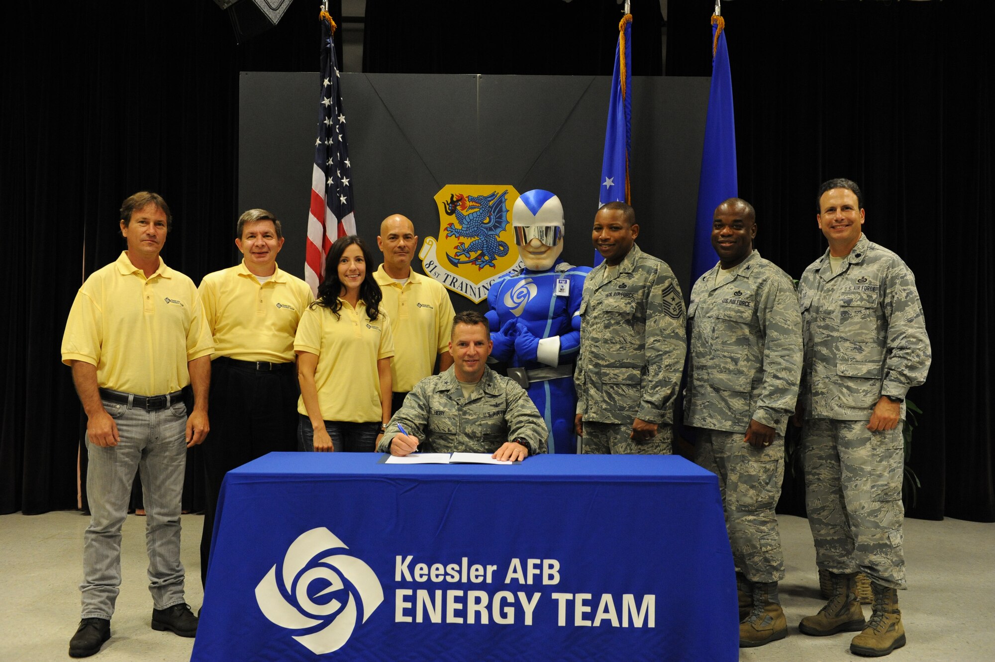 Brig. Gen. Patrick Higby, 81st Training Wing commander, signs the new base energy policy Oct. 11, 2013 with members of the Civil Engineering department and the 81st TRW energy management program, Keesler Air Force Base, Miss. The Energy Action Month campaign began Oct. 10, to initiate more energy savings Air Force-wide. (U.S. Air Force photo by Airman 1st Class Stephan Coleman)