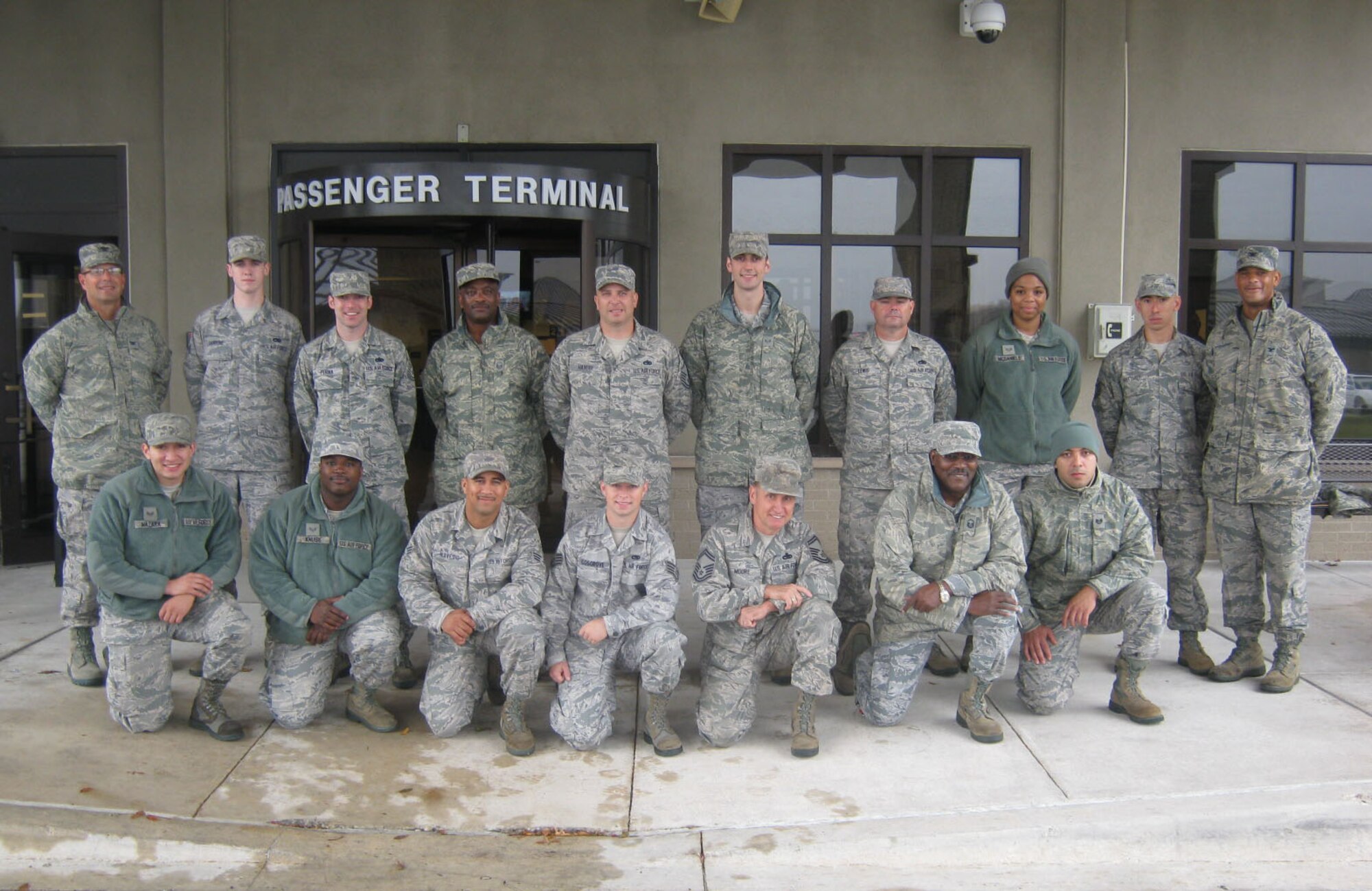Col. Raymond A. Kozak (left), 512th Airlift Wing commander, and Col. Kelvin D. McElroy (right), joins a team of maintainers at the Dover Air Force Base, Del., passenger terminal before their departure to Japan, Oct. 11, 2013. The 512th Maintenance Group members volunteered for the two-week assignment to provide C-5M training to active-duty maintainers assigned to the 730th Air Mobility Squadron, Yokota Air Base, Japan. (U.S. Air Force photo/Master Sgt. Sonia Addison) 