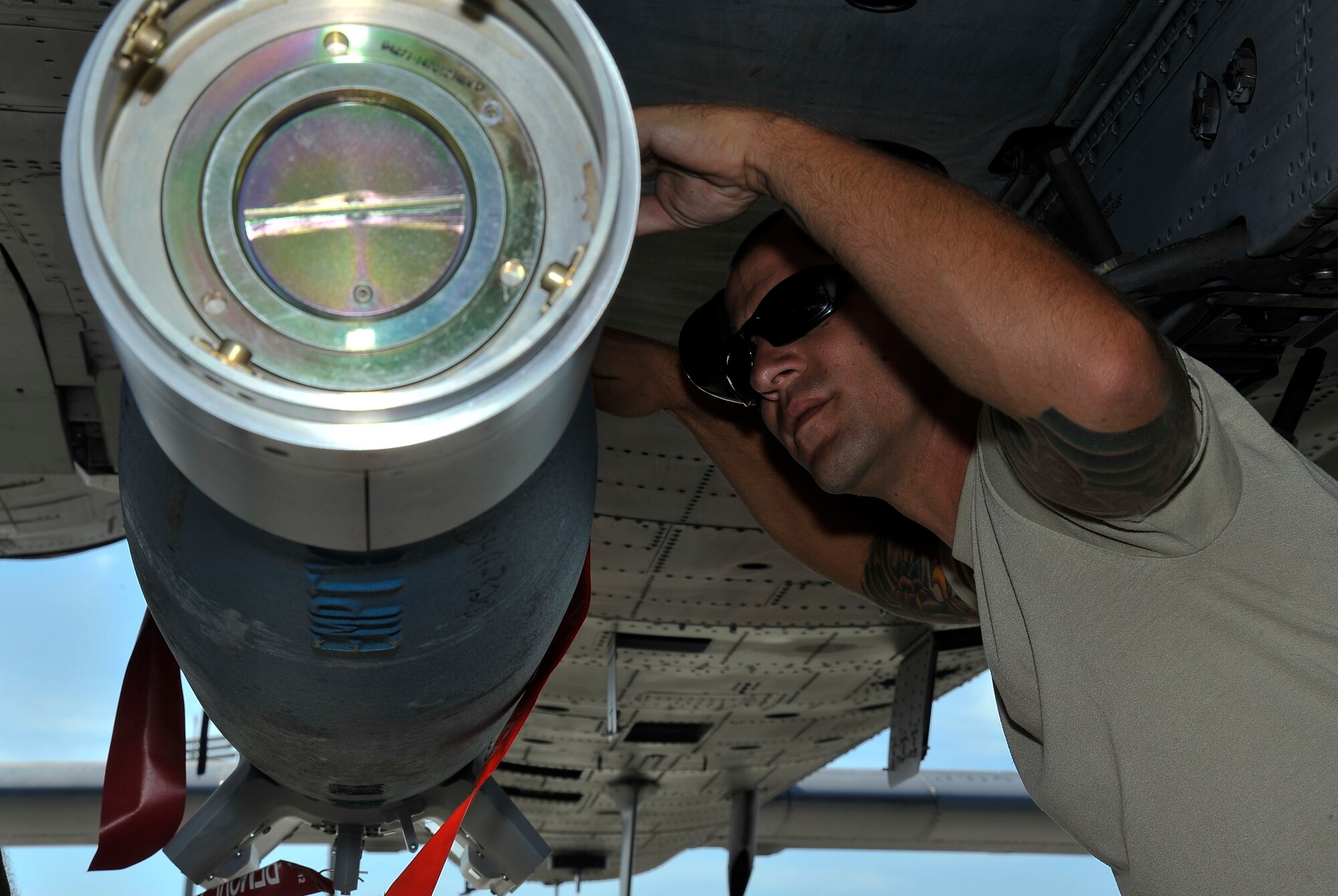Staff Sgt. Justin Pabst, 442nd Maintenance Group weapons load crew member, secures an inert explosive device onto an A-10 Thunderbolt Oct. 8, 2013, at MacDill Air Force Base, Fla. Ten aircraft from the 442nd Fighter Wing visited MacDill from Oct. 1-11 to practice for real world missions. (U.S. Air Force photo by Airman 1st Class Sarah Hall-Kirchner/Released)