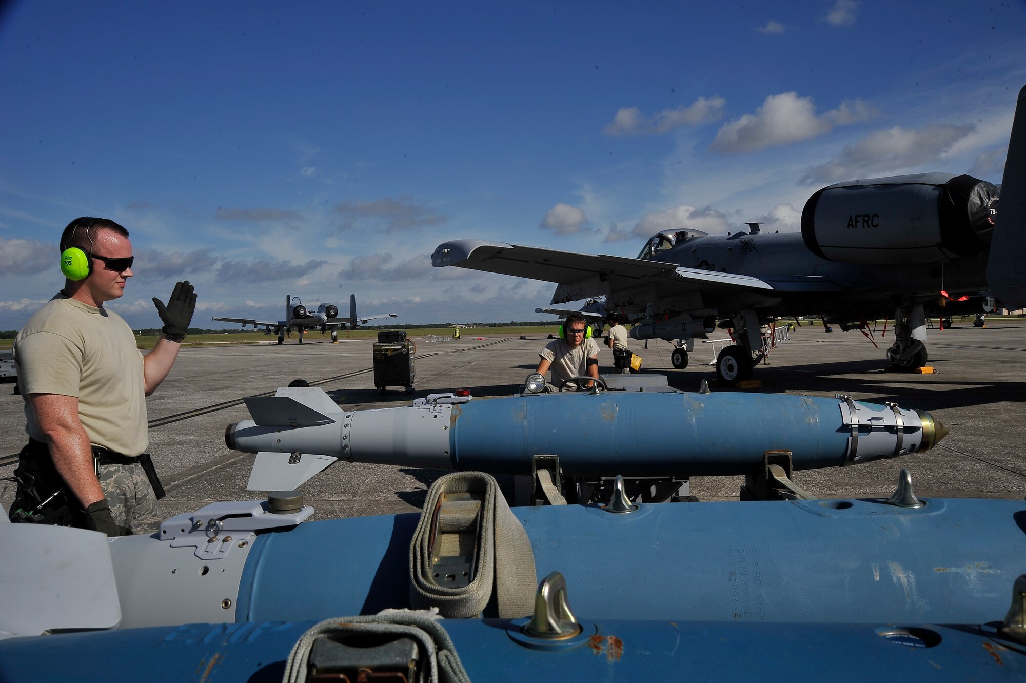 Staff Sgt. Kirk Moore, 442nd Aircraft Maintenance Squadron weapons loading team chief, and Senior Airman Anthony Page, 442nd AMXS A-10 armament specialist, prepare an inert explosive device for use on an aircraft Oct. 8, 2013, at MacDill Air Force Base, Fla. Weapons are loaded under the A-10’s body, which is built to attack tanks, armored vehicles and other ground targets, they have extensive armor allowing them to keep flying even after sustaining damage. (U.S. Air Force photo by Airman 1st Class Sarah Hall-Kirchner/Released)