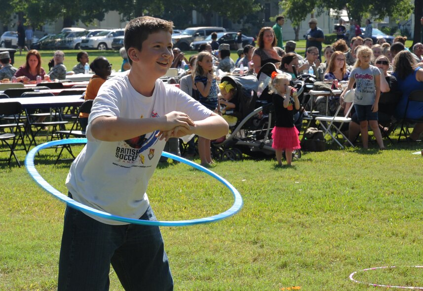 A child participates in a hula hoop contest during Celebrate Barksdale on Barksdale Air Force Base, La., Oct. 11, 2013. The annual event, hosted by the Shreveport-Bossier Military Affairs council, gave the local community a chance to show their appreciation for the military. Festivities included a 5K run, lunch, music and games. (U.S. Air Force photo/Senior Airman Sean Martin)