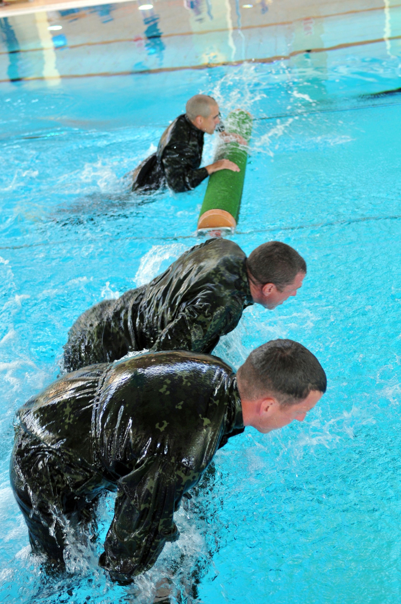 From top to bottom, Pennsylvania National Guard Staff Sgt. Matthew Stern, Air Force Reserve Maj. Brendon Ritz and Pennsylvania National Guard Staff Sgt. Mark Jones, cross over one of the obstacles in the Water Obstacle course during the NATO Military Skills Competition, Aug. 1, 2012. Ritz is an operations officer with the Pacific Command J3. Jones is an Infantry squad leader with Company B, 1st Battalion, 111th Infantry Regiment. Stern is a recruiter with the Pennsylvania National Guard Recruiting Command. The three were competitors with Team USA Military competing at the Pentathlon held in Hoevelte, Denmark. (U.S. Army Photo/1st Sgt. D. Keith Johnson)