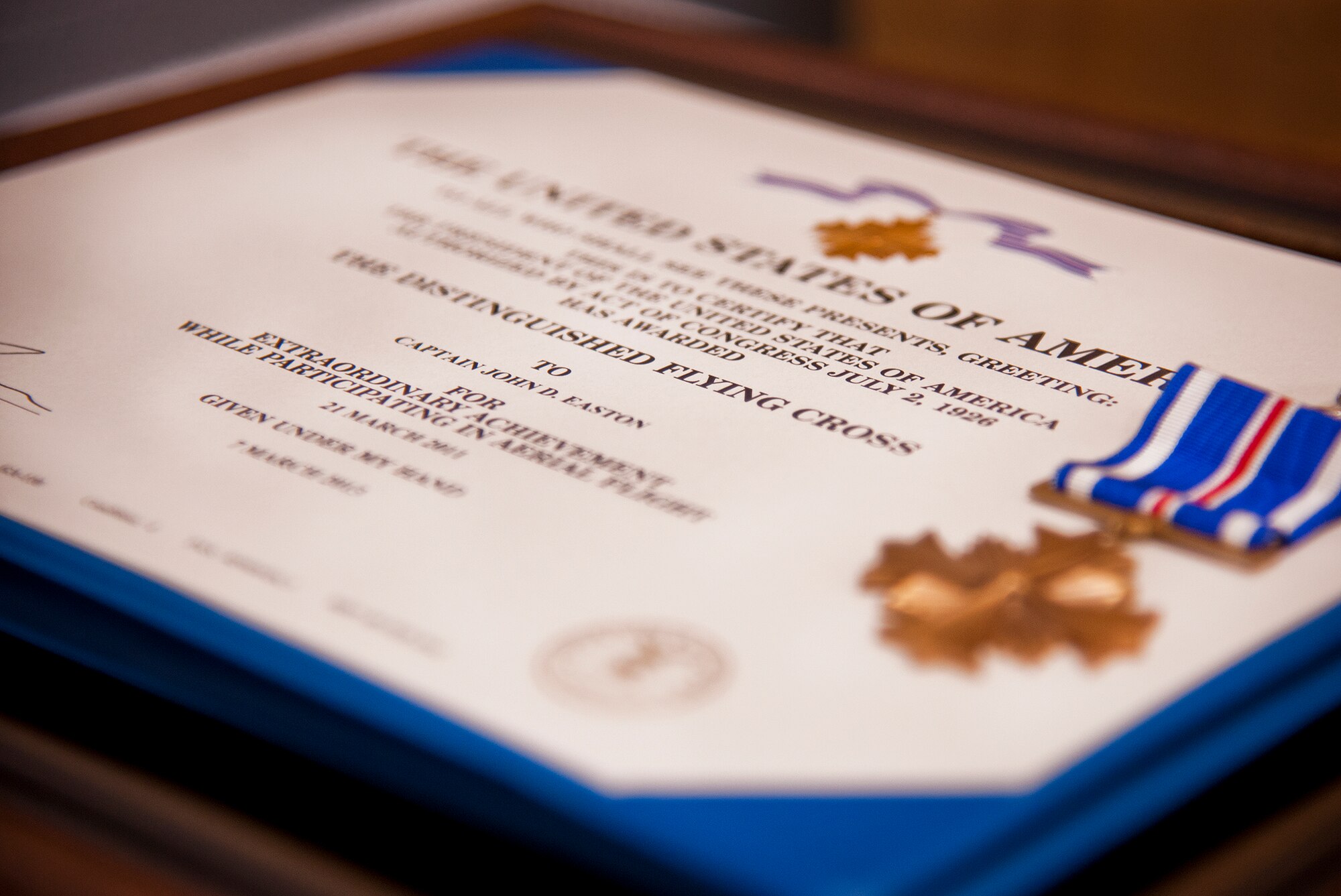The Distinguished Flying Cross medal and certificate wait to be presented to Capt. John Easton, of the 86th Fighter Weapons Squadron, during a ceremony at Eglin Air Force Base, Fla., Oct. 11.  Easton received his medal for his heroic efforts during an F-15E mission in Libya in 2011.  (U.S. Air Force photo/Samuel King Jr.)