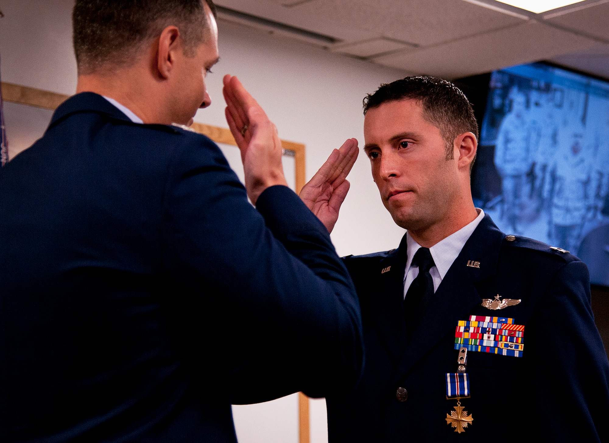 Capt. John Easton, of the 86th Fighter Weapons Squadron, salutes Col. Alexus Grynkewich, the 53rd Wing commander, after receiving a Distinguished Flying Cross during a ceremony at Eglin Air Force Base, Fla., Oct. 11. Easton received his medal for his heroic efforts during an F-15E mission in Libya in 2011.  (U.S. Air Force photo/Samuel King Jr.)