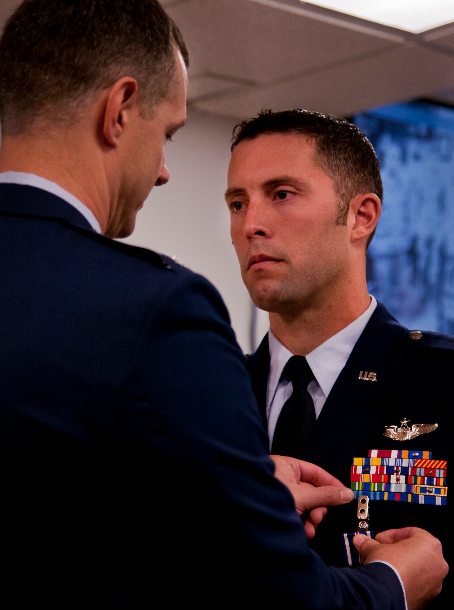 Col. Alexus Grynkewich, the 53rd Wing commander, presents the Distinguished Flying Cross to Capt. John Easton, of the 86th Fighter Weapons Squadron, during a ceremony at Eglin Air Force Base, Fla., Oct. 11.  Easton received his medal for his heroic efforts during an F-15E mission in Libya in 2011.  (U.S. Air Force photo/Samuel King Jr.)