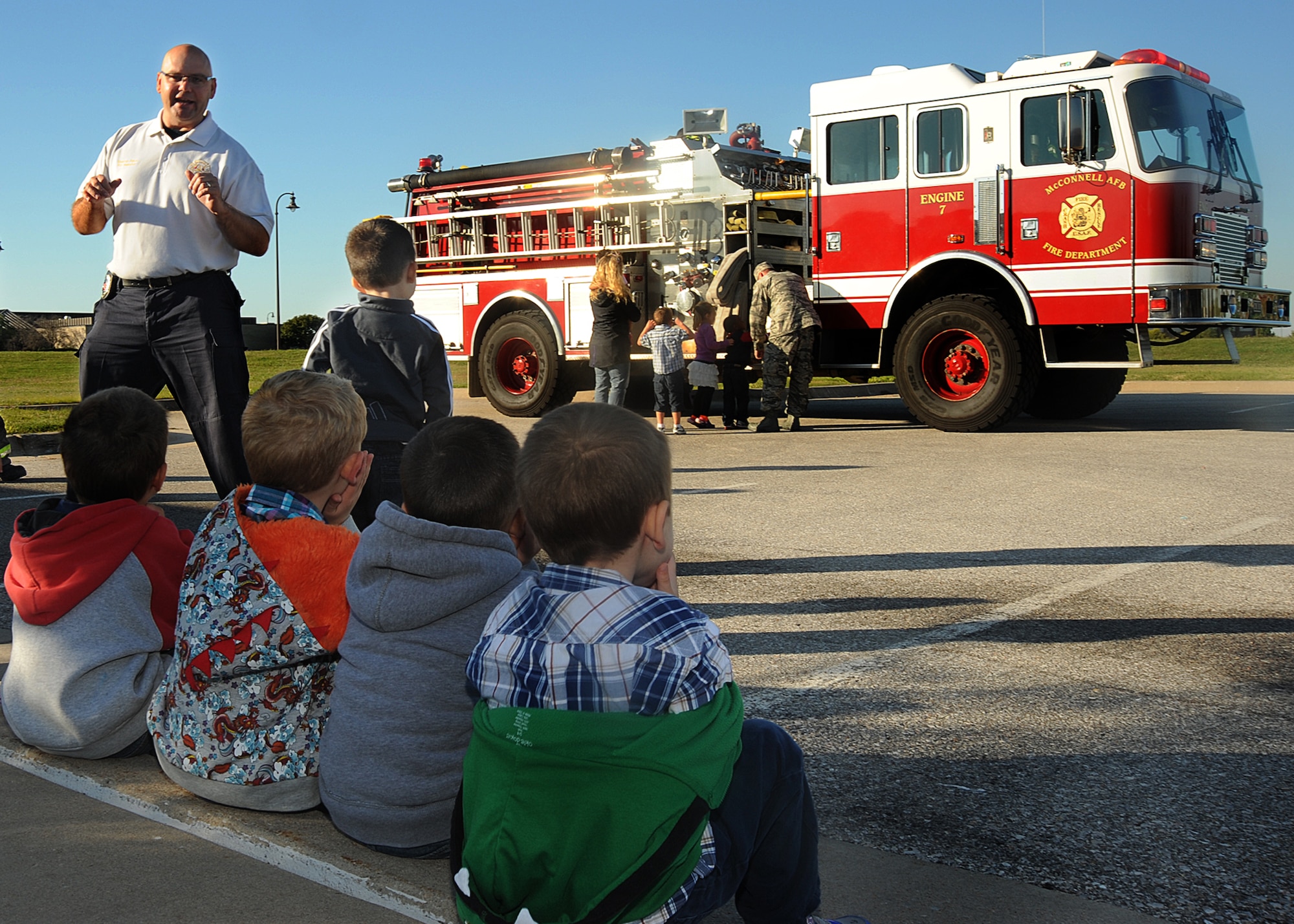 Stephen Patch, 22nd Civil Engineer Squadron fire prevention assistant chief, speaks to children at the Child Development Center about fire safety Oct. 10, 2013, at McConnell AFB, Kan. The McConnell Fire Department is scheduled to hold a fire safety presentation, parade and a base fire muster this month to help increase awareness. (U.S. Air Force photo/Senior Airman Maurice A. Hodges)