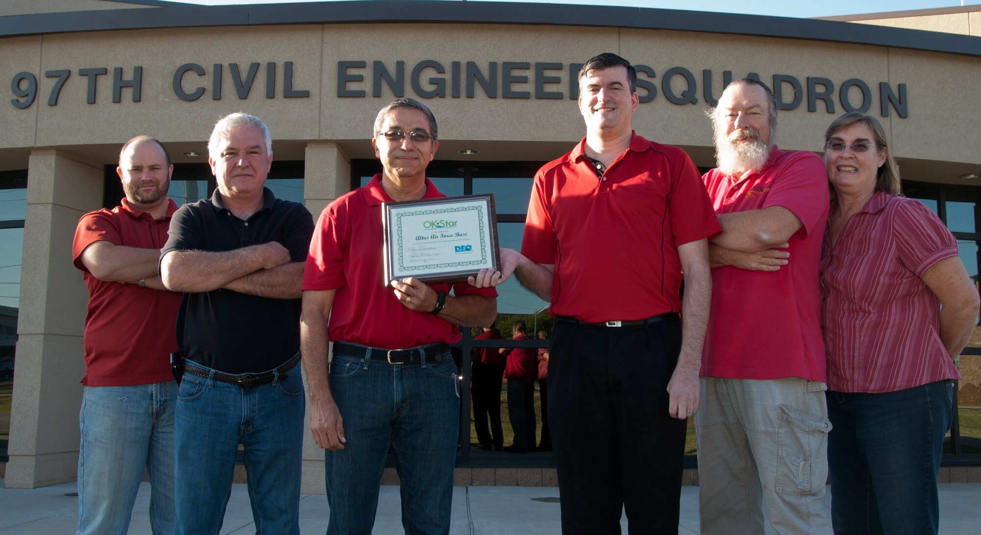 ALTUS AIR FORCE BASE, Okla. – Members of the 97th Civil Engineer Squadron Environmental Office stand outside the 97th Oct. 10, 2013. The environmental office won the Oklahoma Department of Environmental Quality Oklahoma Star Platinum Award Sept. 20, 2013, for their efforts in protecting the base environment. (U.S. Air Force photo by Airman 1st Class Franklin R. Ramos/Released)