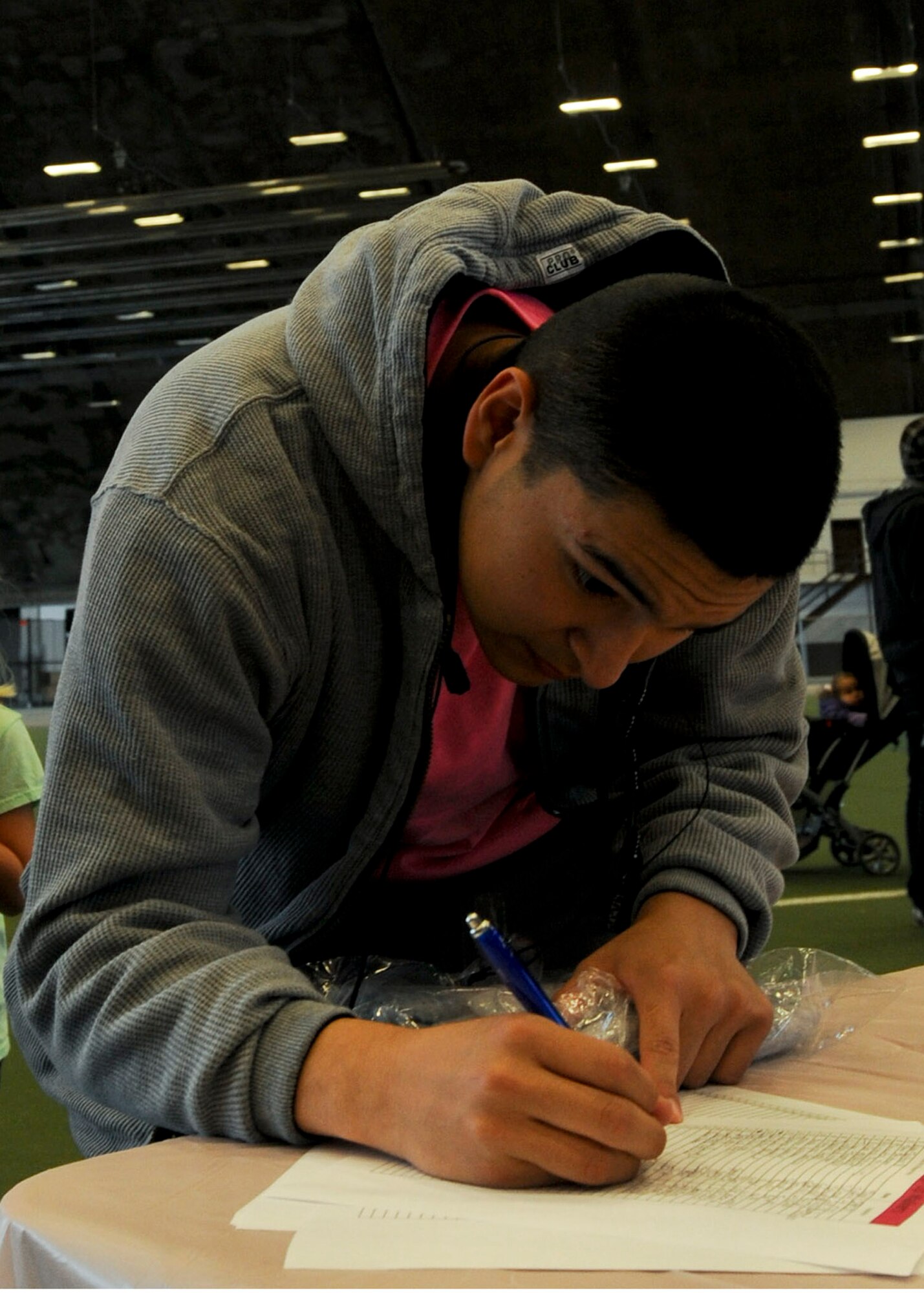 Senior Airman Roger Pedraza, 28th Medical Operations Squadron bio-environmental technician, registers for the Think Pink Breast Cancer awareness 5k run/1.5 mile walk at Ellsworth Air Force Base, S.D., Oct. 3, 2013. The Health and Wellness Center hosted the event as a way of increasing awareness of breast cancer for base Airmen, family members and civilians. (U.S. Air Force photo by Senior Airman Anania Tekurio/Released) 