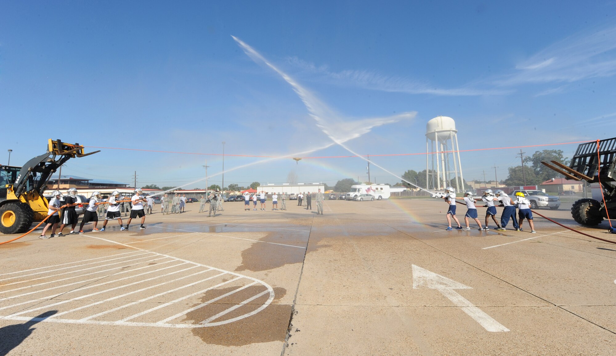 Two teams participate in a hose joust during the third annual Fire Muster Challenge as part of Fire Prevention Week on Barksdale Air Force Base, La., Oct. 10, 2013. The purpose of Fire Prevention Week is to inform the Barksdale community on fire safety and useful fire prevention tips. (U.S. Air Force photo/Senior Airman Sean Martin)