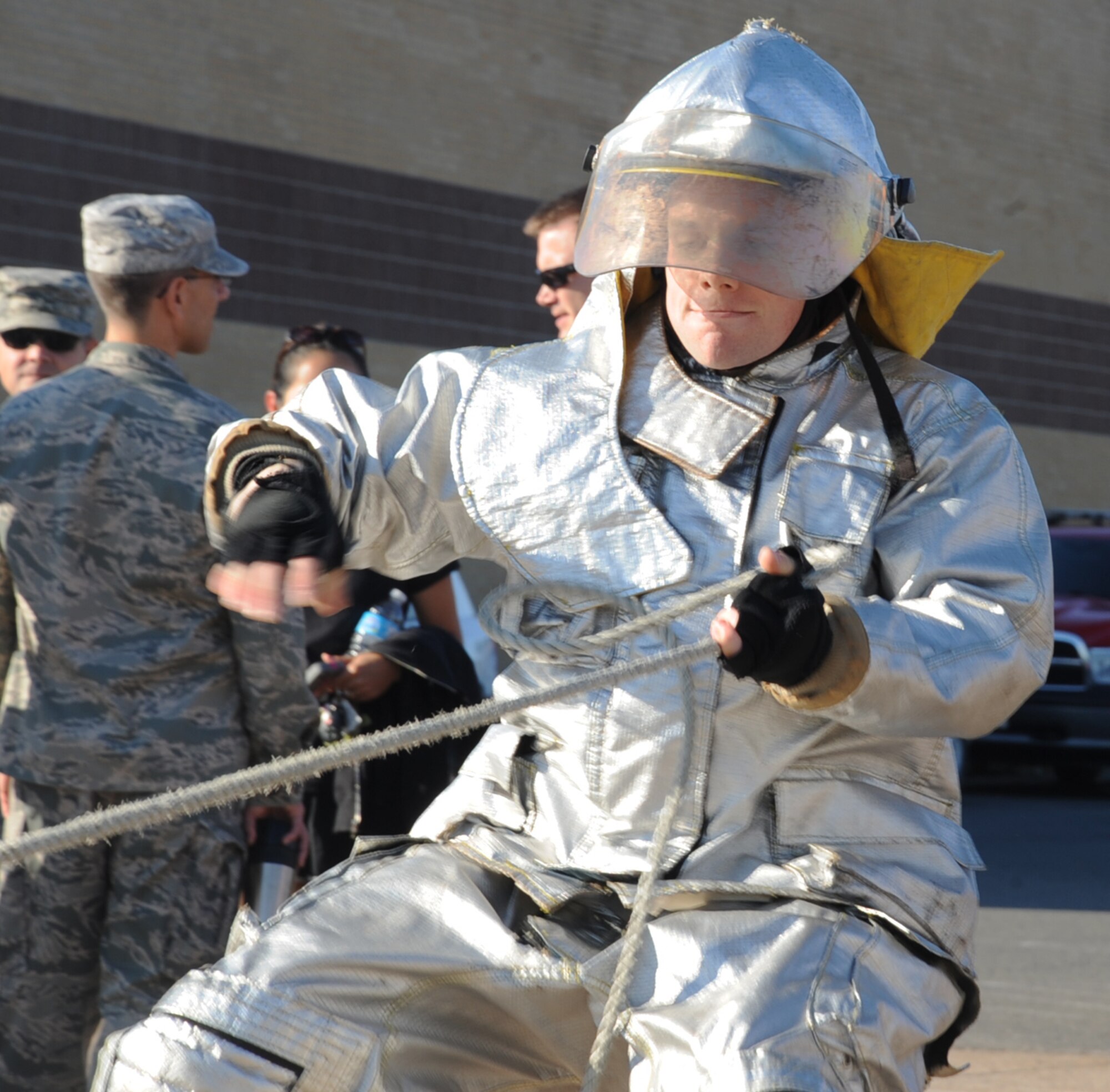 Airman 1st Class Michael Condon, 2nd Comptroller Squadron finance management  journeyman, pulls a hose during the third annual Fire Muster Challenge as part of Fire Prevention Week on Barksdale Air Force Base, La., Oct. 10, 2013. The challenge consisted of a dummy drag, hotel pack, hose pull, Kaiser sled and hose advance. (U.S. Air Force photo/Senior Airman Sean Martin)