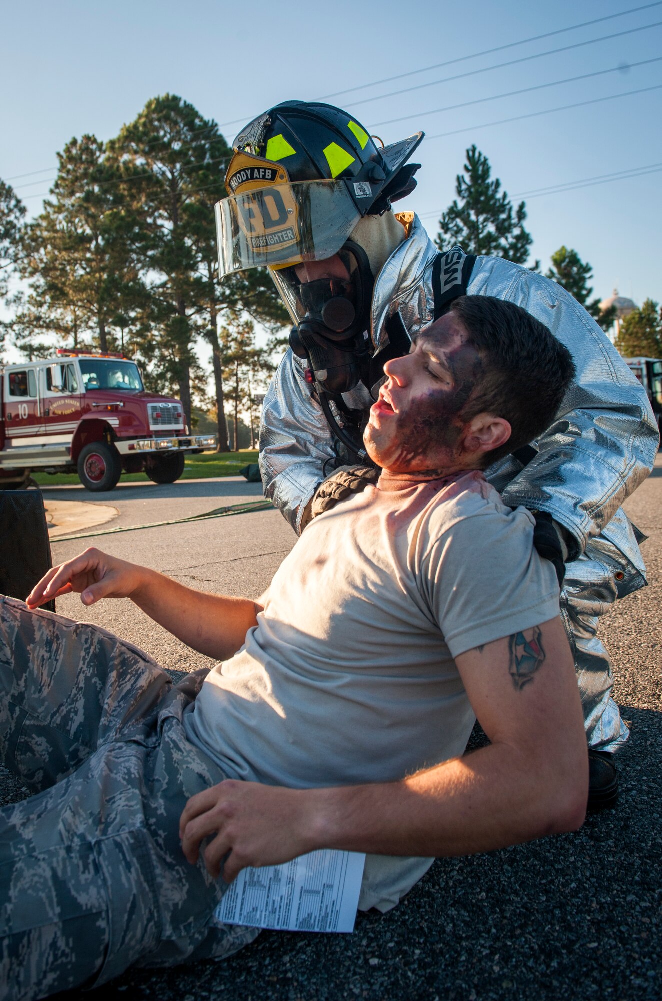 U.S. Air Force Airman 1st Class Joshua Humes, 23d Civil Engineer Squadron firefighter, assists a simulated injured person during a major accident response exercise at Moody Air Force Base, Ga., Sept. 27, 2013. Firefighters were among the first responders and assisted the injured people until they could be treated by medical personnel. (U.S. Air Force photo by Senior Airman Jarrod Grammel/Released)
