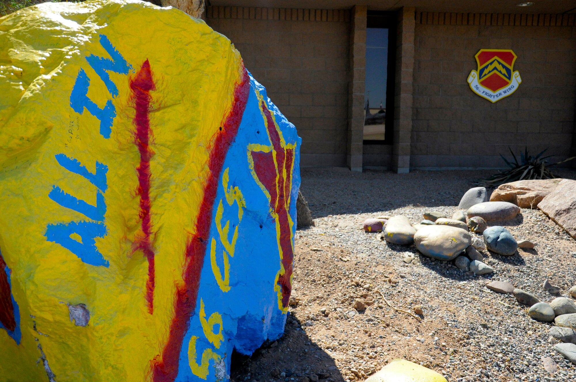 The 56th Fighter Wing commander’s Rock, recently “stolen,” painted and returned by the 56th Civil Engineer Squadron, sits on the north side of the wing headquarter’s building. The challenge to paint the Rock without getting caught was initiated in July 2011 and serves as a competitive team and morale builder. (U.S. Air Force photo/Staff Sgt. Timothy Boyer)