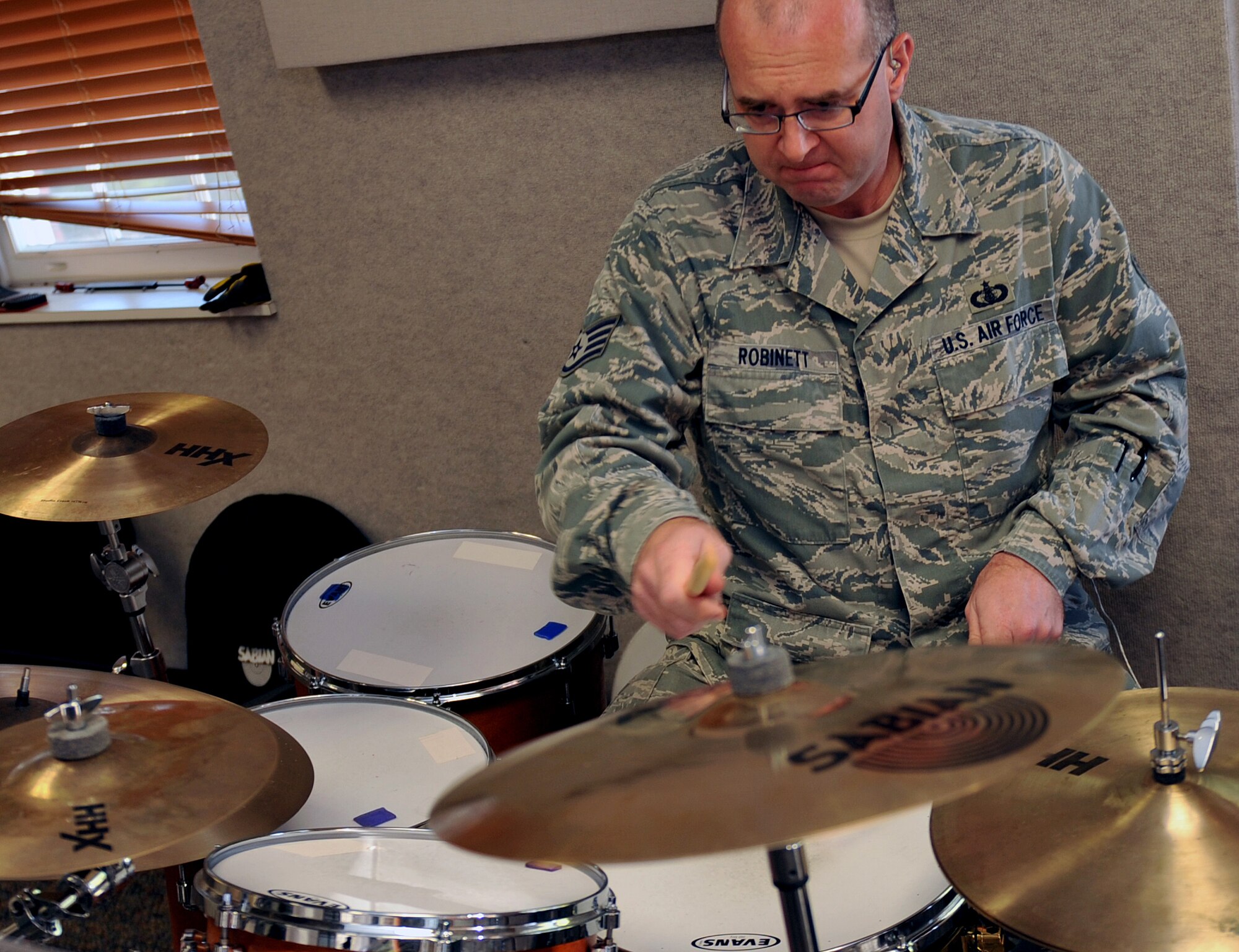 U.S. Air Force Staff Sgt. Jarrett Robinett, a percussionist for the Heartland of America Band, plays drums during a rehearsal Oct. 10, on Offutt Air Force Base, Neb.  The HOAB is categorized as a named activity, which is very similar to a detachment, and falls under the Heritage of America Band chain of command at Joint Base Langley-Eustis, Va.  (U.S. Air Force photo by Jeff W. Gates/Released)