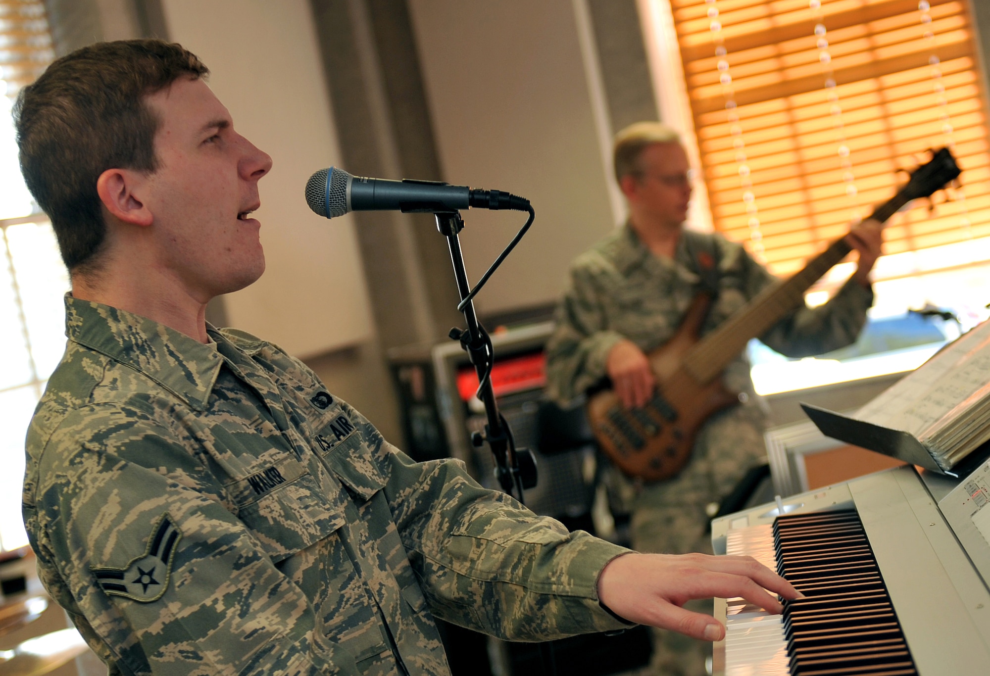 U.S. Air Force Airman 1st Class Adam Walker, a keyboardist for the Heartland of America Band, sings backing vocals during a rehearsal Oct. 10, on Offutt Air Force Base, Neb. The HOAB currently have three named musical ensembles, Raptor, Offutt Brass and Vortex. (U.S. Air Force photo by Jeff W. Gates/Released)