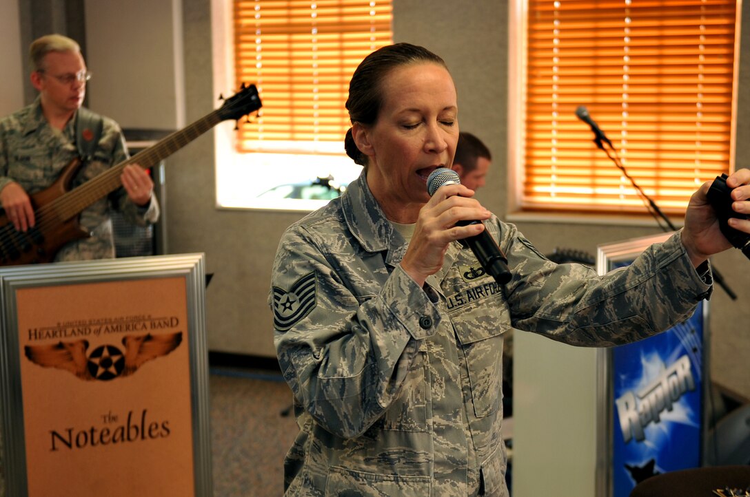 U.S. Air Force Tech. Sgt. Rebecca Packard, a vocalist for the Heartland of America Band, tests her vocal range during a rehearsal Oct. 10, at Offutt Air Force Base, Neb. The HOAB recently transitioned from a 46-piece band to a 16-piece band as part of an overall Air Force restricting. (U.S. Air Force photo by Jeff W. Gates/Released)