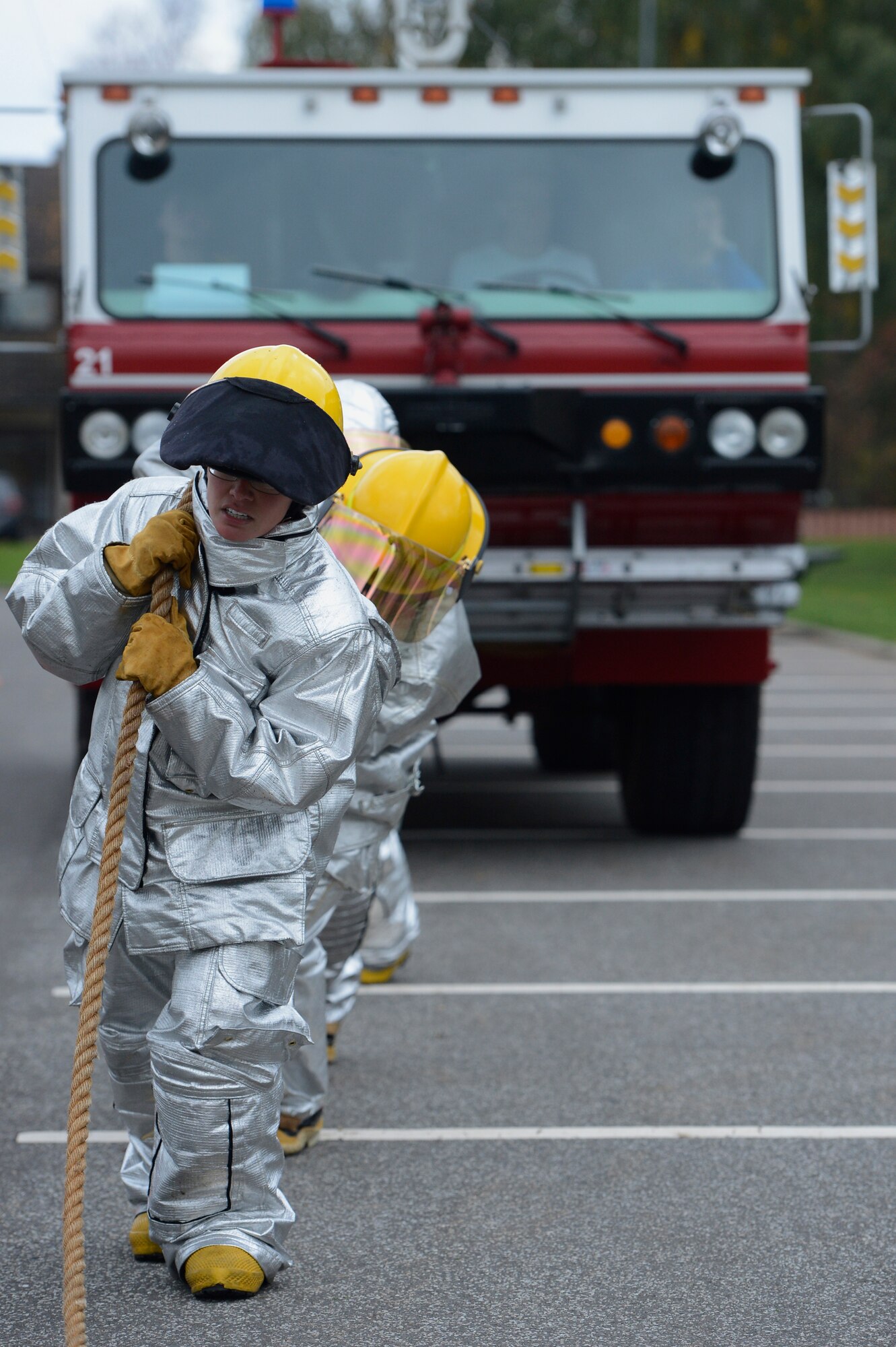 SPANGDAHLEM AIR BASE, Germany – U.S. Air Force Senior Airman Jessica Chapa, 52nd Security Forces Squadron local national screener, leads her four member team in tugging a P-19 fire tuck during the Spangdahlem Fire Prevention Week fire muster event Oct. 10, 2013. The fire muster was hosted during to educate members about fire safety. (U.S. Air Force photo by Staff Sgt. Christopher Ruano/Released)