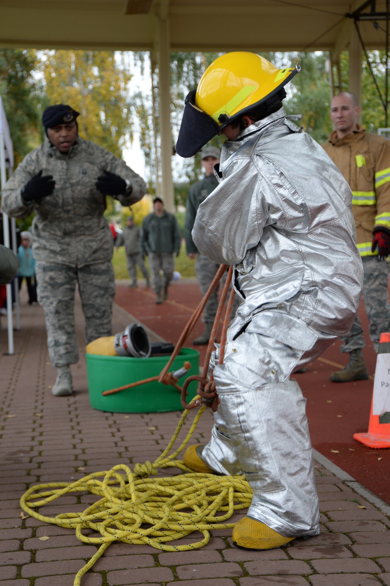 SPANGDAHLEM AIR BASE, Germany – U.S. Air Force Senior Airman Jessica Chapa, 52nd Security Forces Squadron local national screener from San Antonio, pulls a weighted bucket during one of the challenges in the Fire Muster competition Oct. 10, 2013. The competition coincided with many other fire awareness-themed events as part of Fire Prevention Week. (U.S. Air Force photo by Airman 1st Class Dylan Nuckolls/Released)