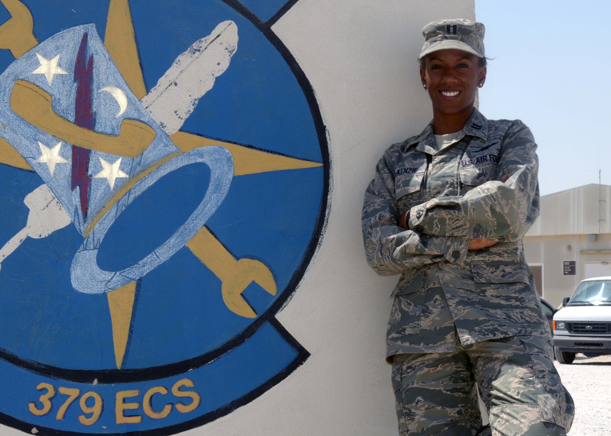 Capt. Charneice McKenzie poses beside a barrier at the 379th Air Expeditionary Wing in Southwest Asia, Sept. 25, 2013. McKenzie distinguished herself among her peers and was selected to receive a Science, Technology, Engineer and Math award sponsored by Women of Color Magazine. She is the 379th Expeditionary Communications Squadron plans and implementation flight commander here on a one-year rotation and a Lewisport, Ky., native. (U.S. Air Force photo/Senior Airman Bahja J. Jones) 