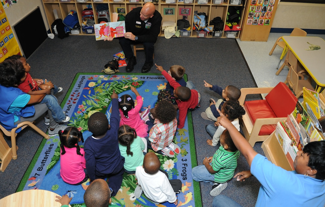 Michael Nicklow, 11th Civil Engineer Squadron fire inspector, reads to a group of children at the child development center on JOINT BASE ANDREWS, Md., Oct. 10, 2013. The children learn about fire safety during National Fire Prevention Week. (U.S. Air Force photo/Airman 1st Class Joshua R. M. Dewberry) 