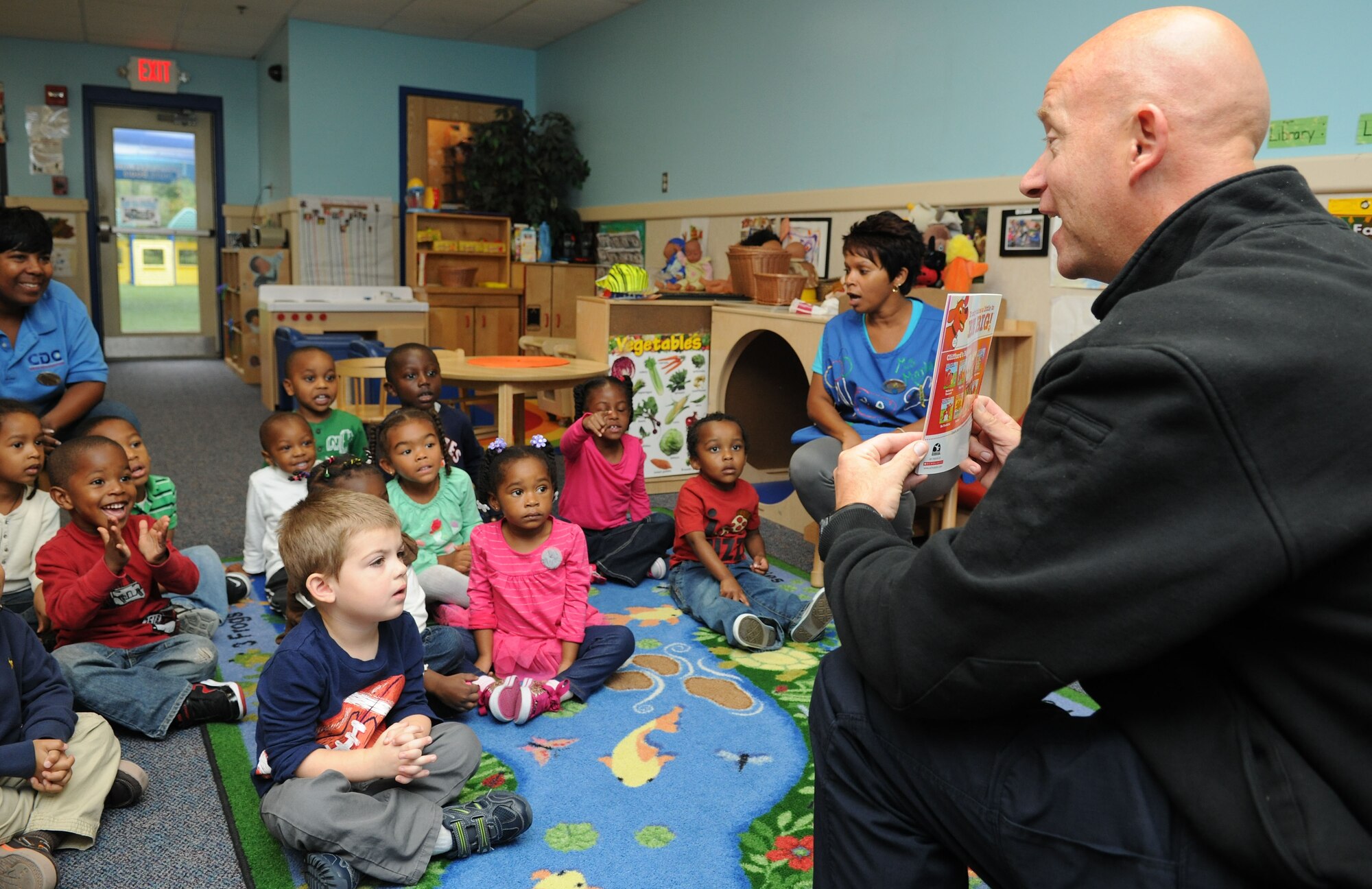 Michael Nicklow, 11th Civil Engineer Squadron fire inspector, engages with a group of children at the child development center on Joint Base Andrews, Md., Oct. 10, 2013. The children learn about fire safety during National Fire Prevention Week. (U.S. Air Force photo/Airman 1st Class Joshua R. M. Dewberry) 