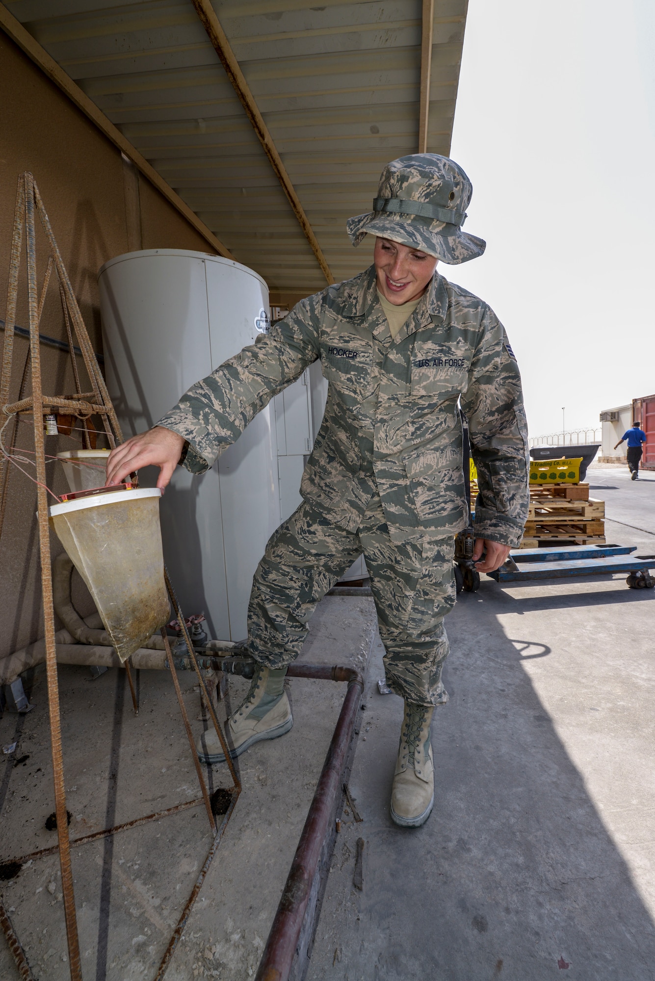 Senior Airman Jordan Hocker inspects a fly bag behind the dining facility at the 379th Air Expeditionary Wing in Southwest Asia, Oct. 8, 2013. Pest management Airmen perform random inspections base wide to assure quality conditions. Hocker is a 379th Expeditionary Civil Engineer Squadron pest management journeyman deployed from Ramstein Air Base, Germany, and hails from Indianapolis. (U.S. Air Force photo/Tech. Sgt. Joselito Aribuabo)