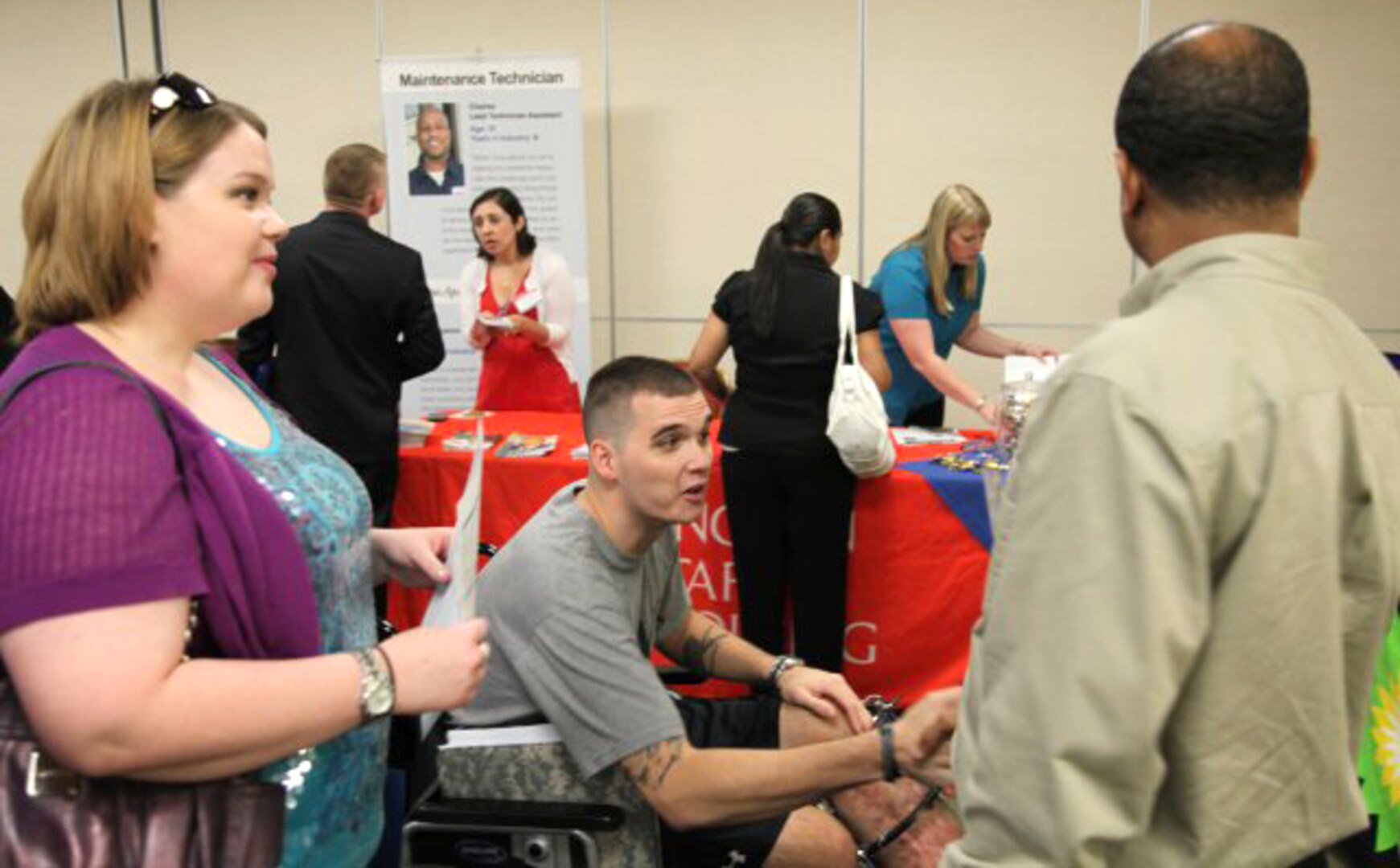 A wounded warrior meets with a recruiter at the Joint Base San Antonio-Fort Sam Houston Defense Department Hiring Heroes Career Fair at the Sam Houston Community Center Sept. 18 to explore employment opportunities after leaving the military. Hiring Heroes Career Fair representatives work with transitioning military, their spouses and veterans hoping to match individual skill sets to a potential employer’s specific needs. (Photo by Robet Dozier, US Army Installation Magaement Command Public Affairs)

