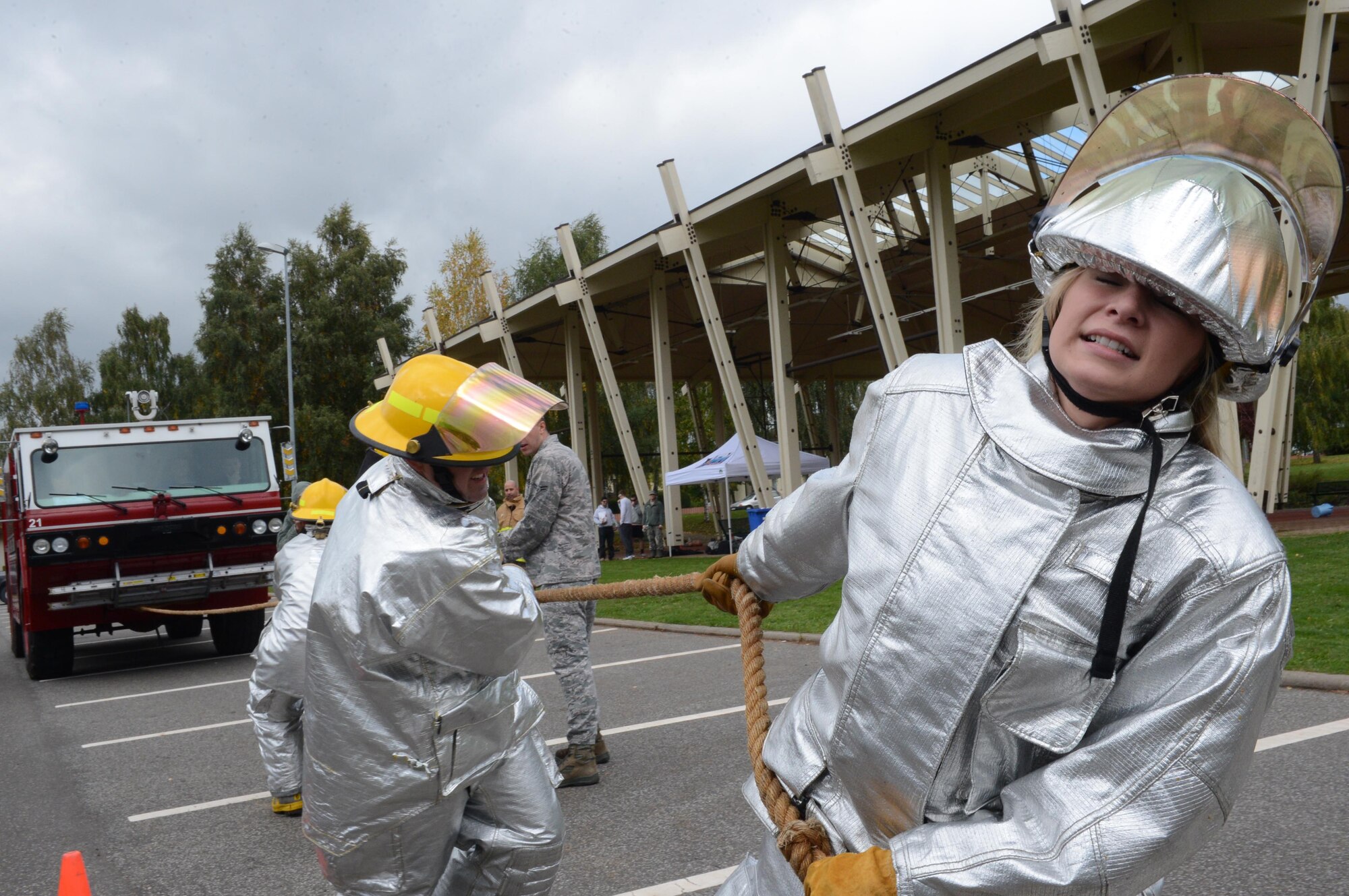 SPANGDAHLEM AIR BASE, Germany – U.S. Air Force Senior Airman Alexis Siekert, 52nd Fighter Wing Public Affairs photojournalist from Milwaukee, aids her teammates in pulling a fire truck during a fire muster competition Oct. 10, 2013. The competition included several obstacles Airmen had to overcome while being timed. The team to complete the course in the shortest amount of time was deemed the winner. (U.S. Air Force photo by Airman 1st Class Kyle Gese/Released)