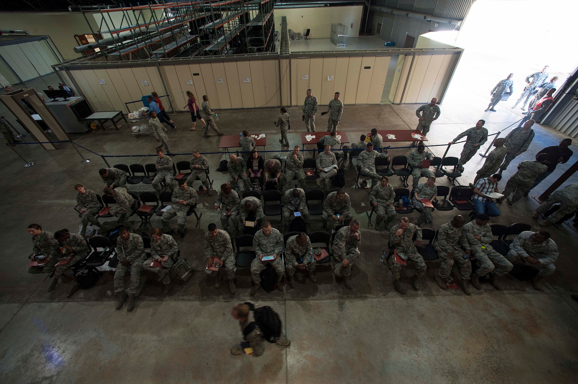 Airmen sit and wait to process their family members and pets through the line during a noncombatant evacuation operation exercise Sept. 27, 2013, at Incirlik Air Base, Turkey.  Evacuee eligibility includes civilian employees of all U.S. government agencies, except those deemed emergency, essential. (U.S. Air Force photo by Airman 1st Class Nicole Sikorski/Released) 