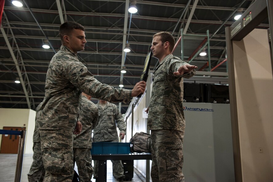 Staff Sgt. Samuel Trutna, 39th Communications Squadron cable and antenna maintenance supervisor, goes through a security screening during a noncombatant evacuation operation exercise Sept. 27, 2013, at Incirlik Air Base, Turkey.  While there are no current plans to evacuate Incirlik AB, the 39th AB Wing ensures that it is always ready. (U.S. Air Force photo by Airman 1st Class Nicole Sikorski)