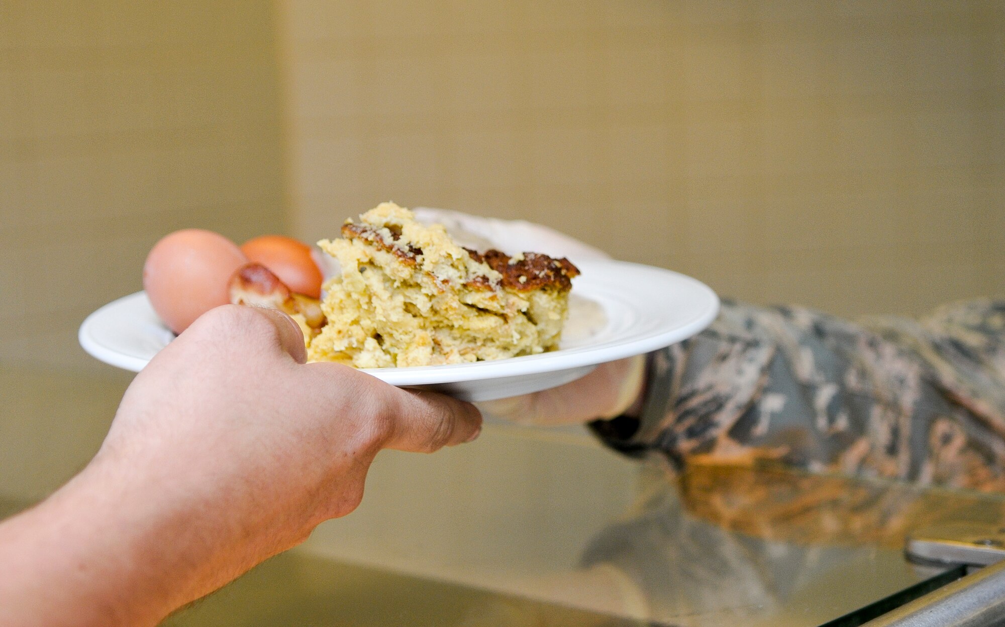 A customer of the Rhineland Inn Dining Facility receives their food Oct. 7, 2013, Ramstein Air Base, Germany. More than 700 Ramstein members visit the DFAC daily. (U.S. Air Force photo/Senior Airman Jose L. Leon)