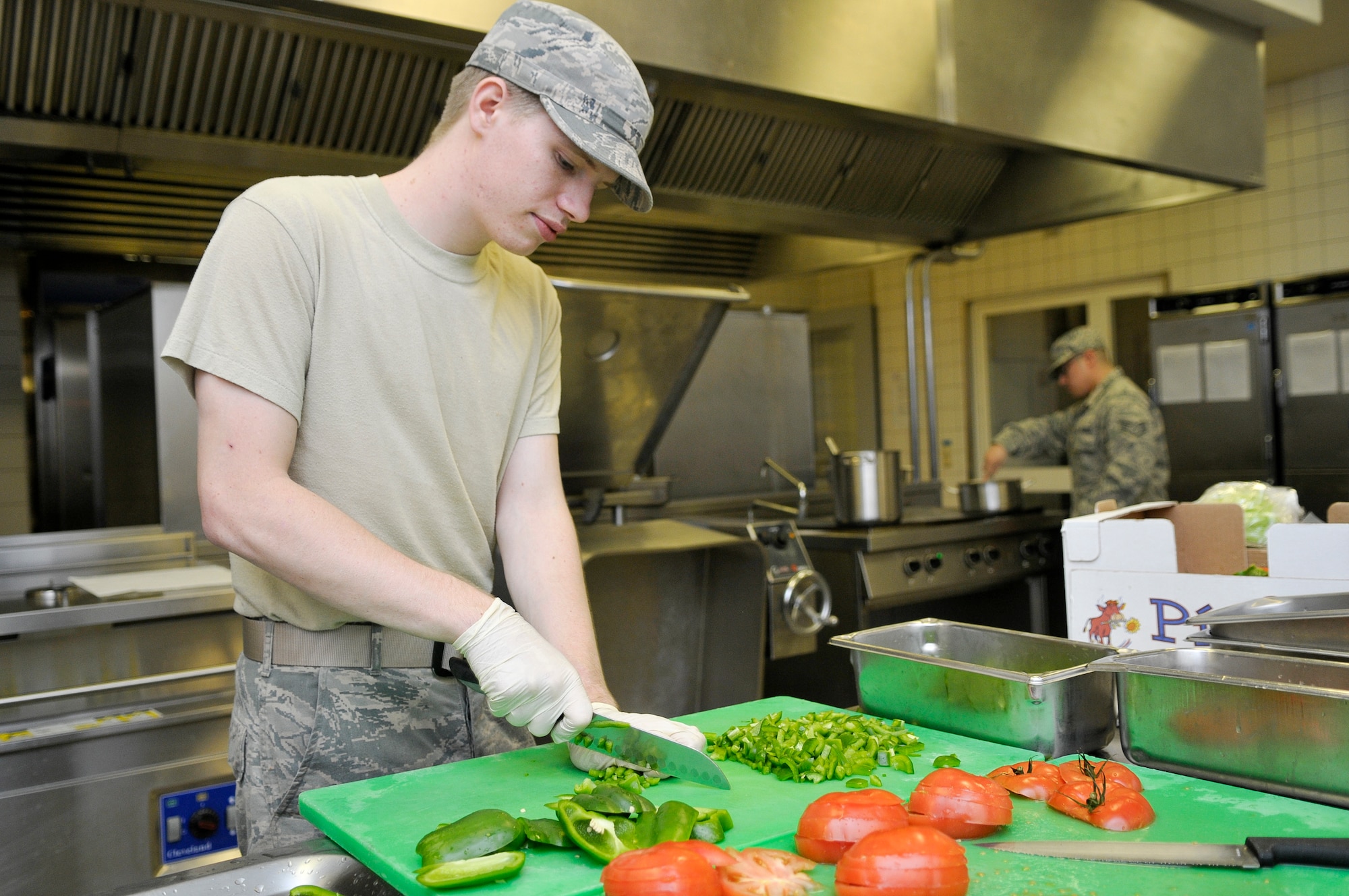 Airman 1st Class Austin Ballinger, 786th Force Support Squadron food services technician, prepares vegetables for midnight chow, Oct. 7, 2013, Ramstein Air Base, Germany. The Rhineland Inn Dining Facility offers four meals a day in order to provide a low-budget meal option for Airmen working around-the-clock shifts. (U.S. Air Force photo/Senior Airman Jose L. Leon)