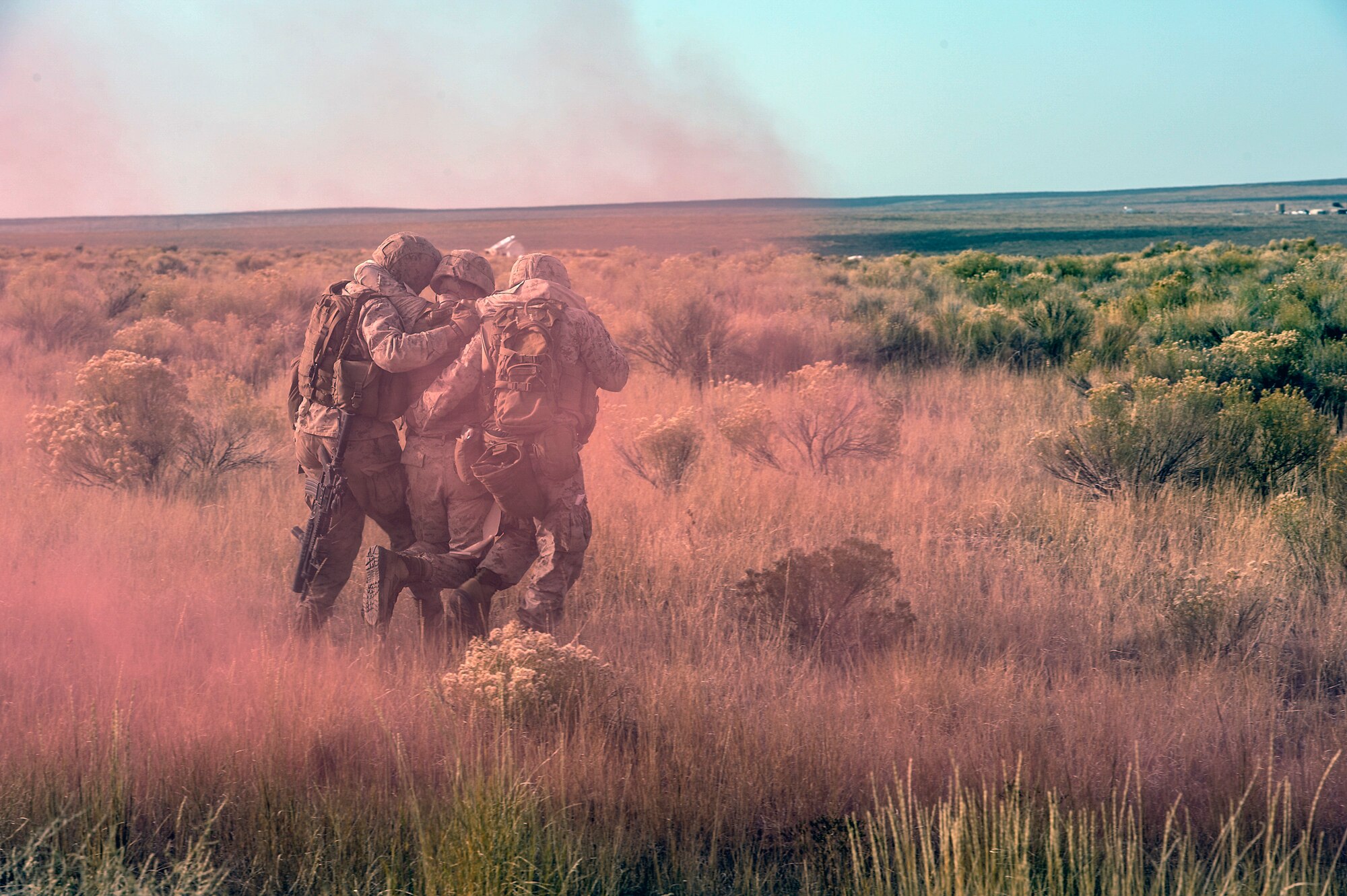 U.S. Marines from the 1st Air Naval Gunfire Liaison Company Supporting Arms Liaison Team, who have been training in the Idaho desert since Sept. 30, 2013, carry their officer-in-charge, Capt. Charles Watt, off the battlefield after he’s –simulated-- hit with a mortar, near Mountain Home Air Force Base, Idaho, Oct. 9, 2013. For SALT officers or NCOs leading strikes, command and control is essential, as is communication. (U.S. Air Force photo by Master Sgt. Kevin Wallace/RELEASED)