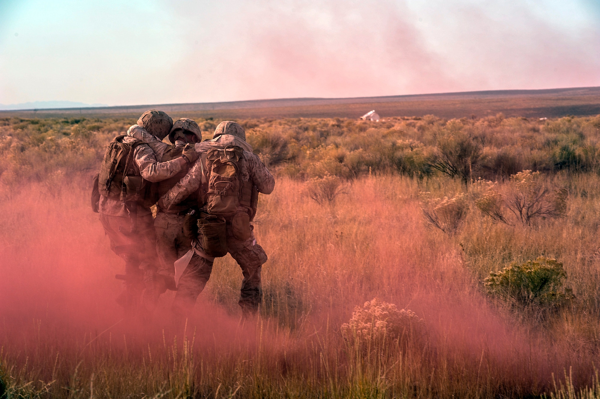 U.S. Marines from the 1st Air Naval Gunfire Liaison Company Supporting Arms Liaison Team, who have been training in the Idaho desert since Sept. 30, 2013, carry their officer-in-charge, Capt. Charles Watt, off the battlefield after he’s –simulated-- hit with a mortar, near Mountain Home Air Force Base, Idaho, Oct. 9, 2013. Partnering with coalition or joint partners isn't a new concept for ANGLICO SALT Marines. In fact, they've been doing it since World War II. Watt and several other 1st ANGLICO Marines from SALT-D recently returned from Afghanistan, where they were attached to the 32nd Georgian Light Infantry Battalion, where the SALT Marines employed their role as the forward liaison and fire-support element. (U.S. Air Force photo by Master Sgt. Kevin Wallace/RELEASED)