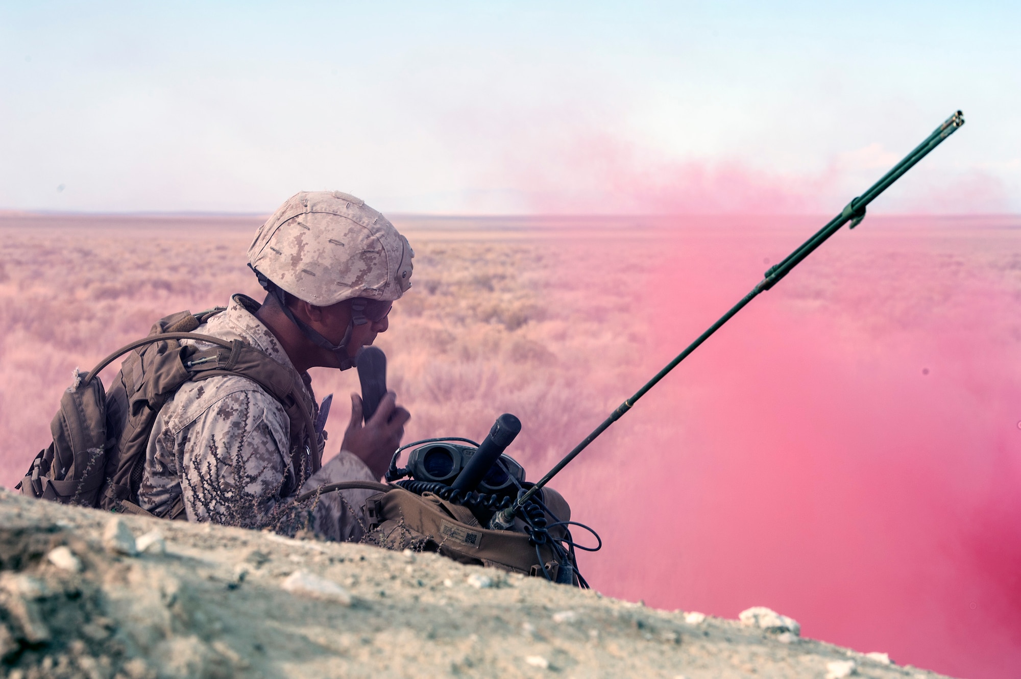 U.S. Marine Cpl. Daniel Soto, 1st Air Naval Gunfire Liaison Company Supporting Arms Liaison Team, works a close-air support mission the Idaho desert since Sept. 30, 2013, lays prone scanning for enemy activity at a Juniper Butte Bombing Range mock village near Mountain Home Air Force Base, Idaho, Oct. 9, 2013, during exercise Mountain Roundup. Mountain Roundup goes beyond Marines; it's an opportunity for a major coalition partner nation - Germany - to certify proficiency on mission employment tasks. It's the 1st ANGLICO SALT who provides realistic training scenarios while re-qualifying their joint terminal air controller proficiencies and polishing urban kinetics. (U.S. Air Force photo by Master Sgt. Kevin Wallace/RELEASED)