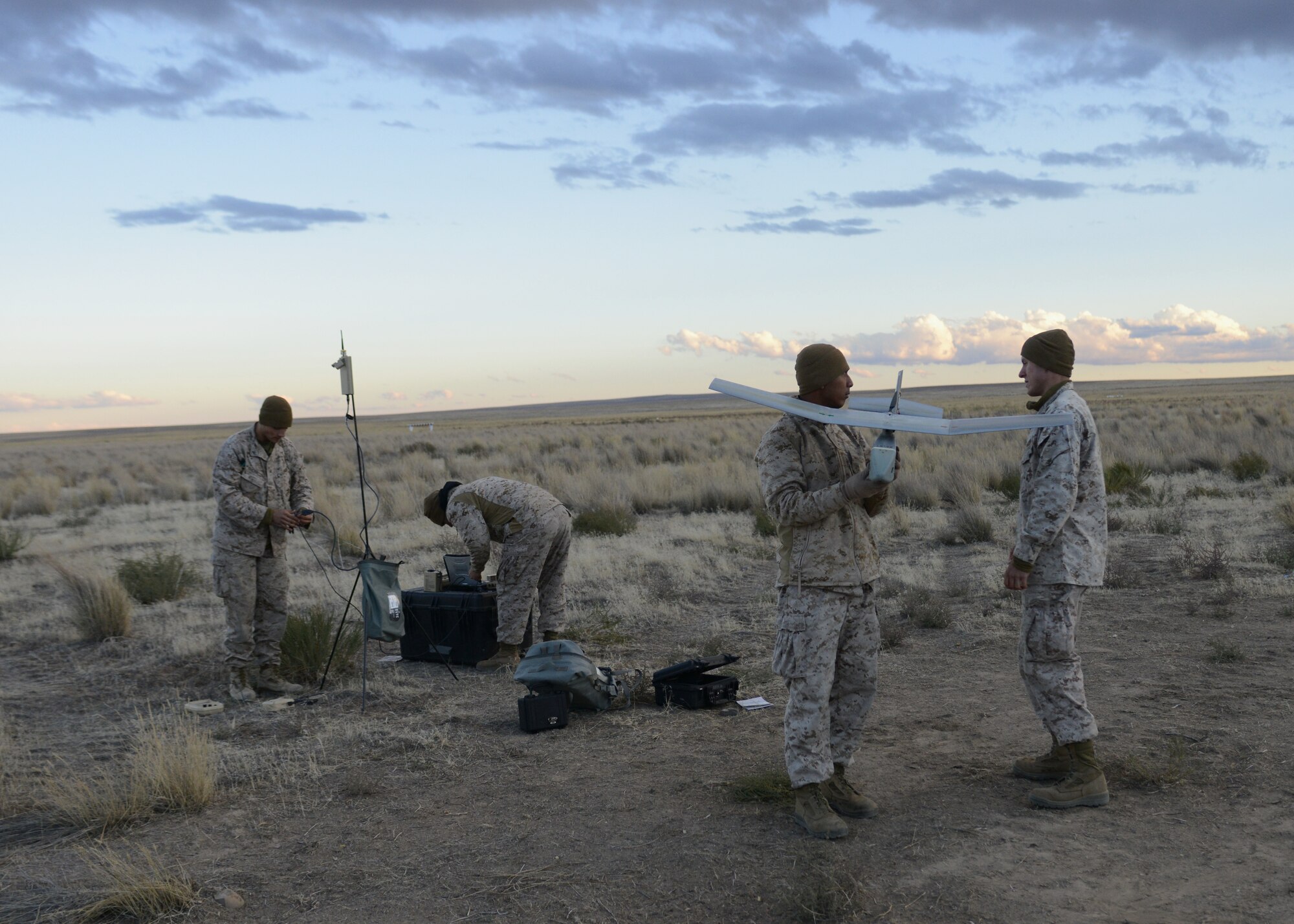 U.S. Marines from 1st ANGLICO work together to put together the RQ-11B Raven Oct. 9, 2013, at the Saylor Creek range. The smallest of ANGLICO’s unmanned aerial systems, the Raven has a wingspan of four feet-six inches, weighs four pounds, has a flight endurance of 60–90 minutes and an effective operational radius of approximately 6.2 miles. (U.S. Air Force photo by Senior Airman Benjamin Sutton/RELEASED) 