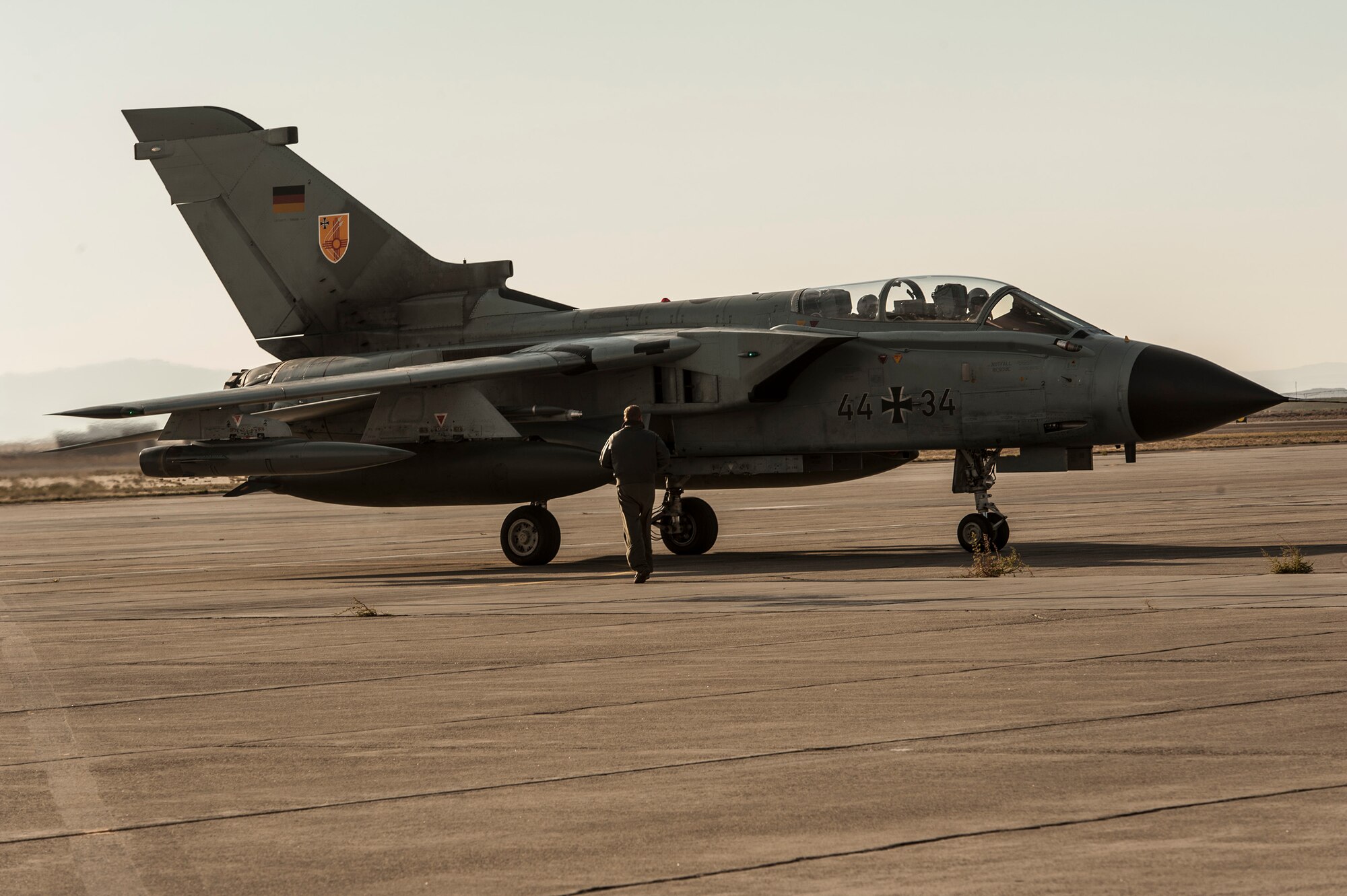A German Air Force crewchief performs post-flight checks on an AG-51 Tornado at Mountain Home Air Force Base, Idaho, Oct. 10, 2013, during exercise Mountain Roundup 2013. The base and the 266th Range Squadron control and maintain emitter sites across almost 7,500-square miles of operational range space, and it's that access to airspace and ranges that allows for realistic, safe training and testing while providing the flexibility to accommodate the complexity of this multinational, multiservice exercise. (U.S. Air Force photo by Master Sgt. Kevin Wallace)