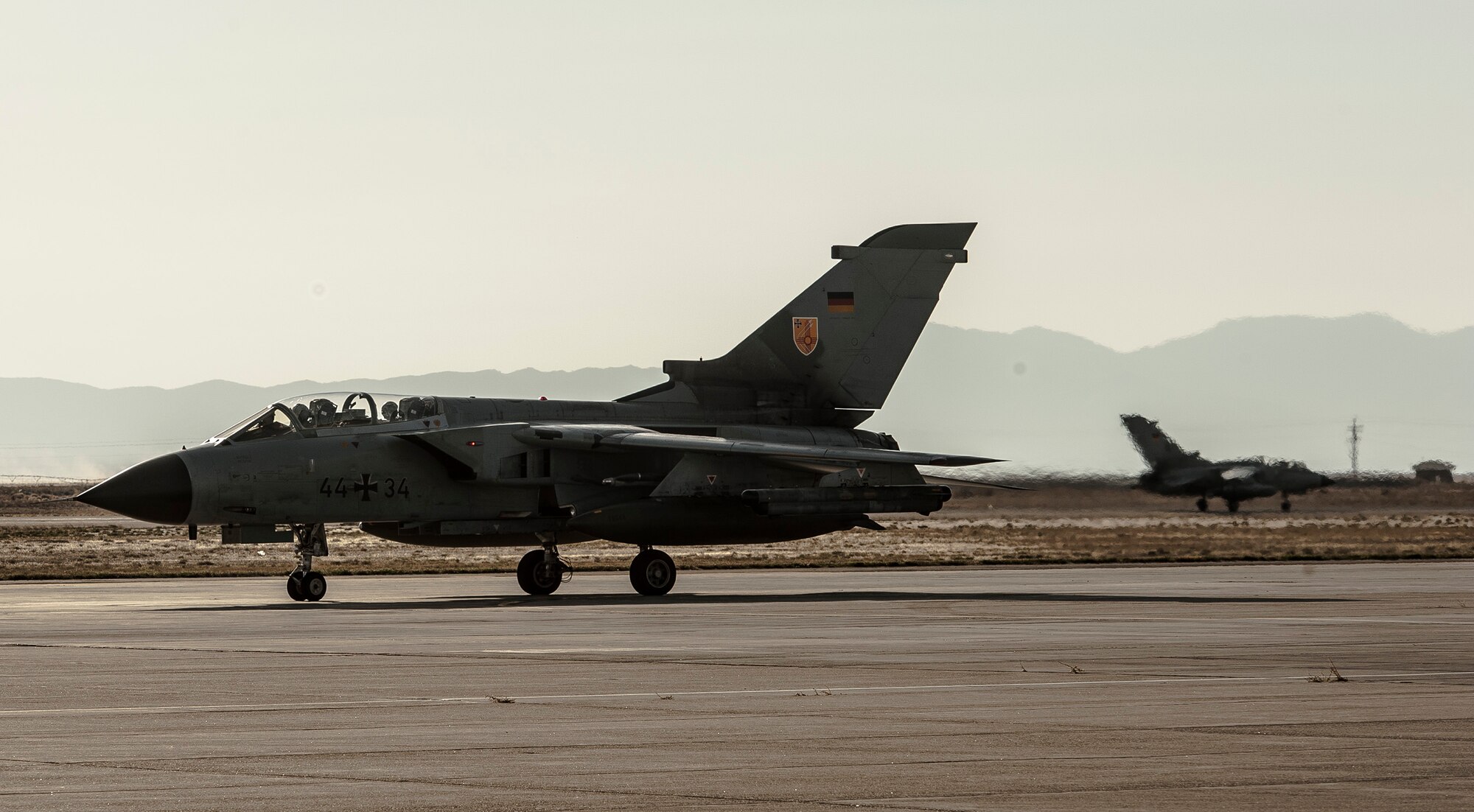 A German Air Force AG-51 Tornado taxis to park as another Tornado comes in for a landing at Mountain Home Air Force Base, Idaho, Oct. 10, 2013, during exercise Mountain Roundup 2013. The exercise is part of the German Air Force Tornado Fighter Weapons Instructor Course Mission Employment Phase, and is scheduled to end Oct. 16. (U.S. Air Force photo by Master Sgt. Kevin Wallace)