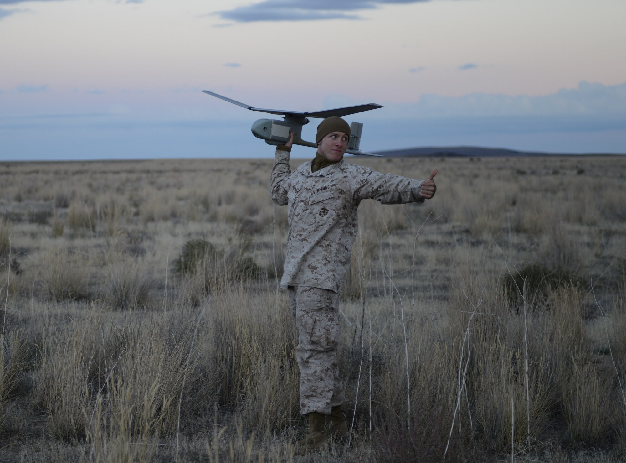 Marine Lance Cpl. Nicholas Thompson, 1st ANGLICO forward observer from Clinton, Iowa, prepares to launch the RQ-11B Raven Oct. 9, 2013, at the Saylor Creek range. The smallest of ANGLICO’s unmanned aerial systems, the Raven has a wingspan of four feet-six inches, weighs four pounds, has a flight endurance of 60–90 minutes and an effective operational radius of approximately 6.2 miles. (U.S. Air Force photo by Senior Airman Benjamin Sutton/RELEASED) 